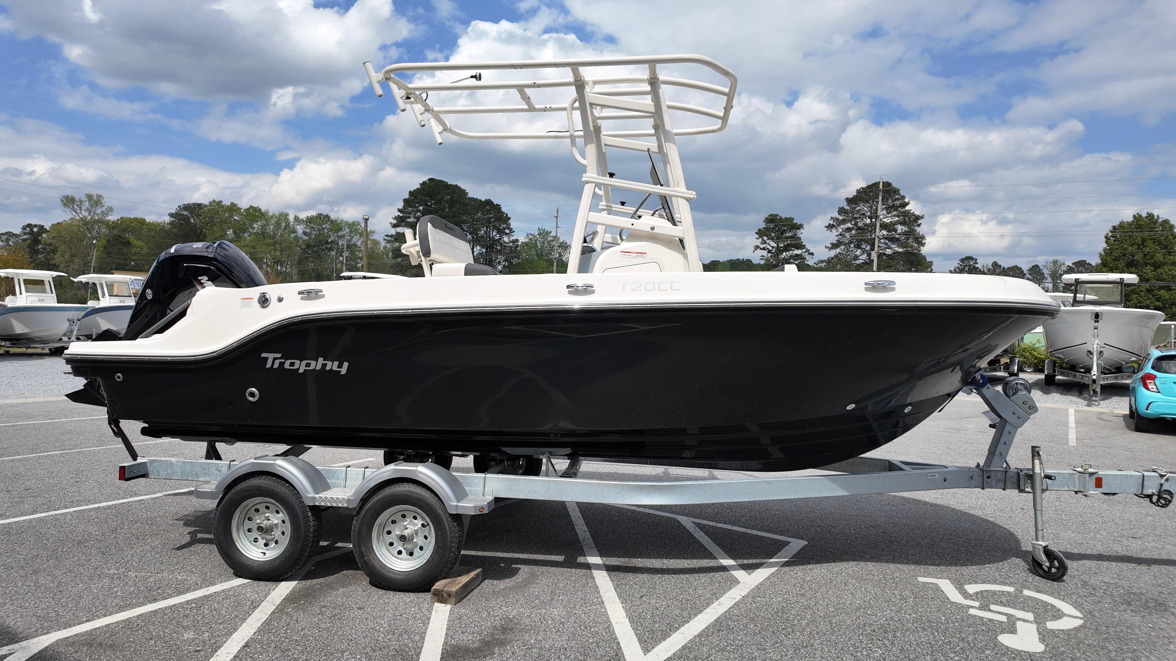 2025 Bayliner Trophy 20 boat on trailer in parking lot, under cloudy sky.