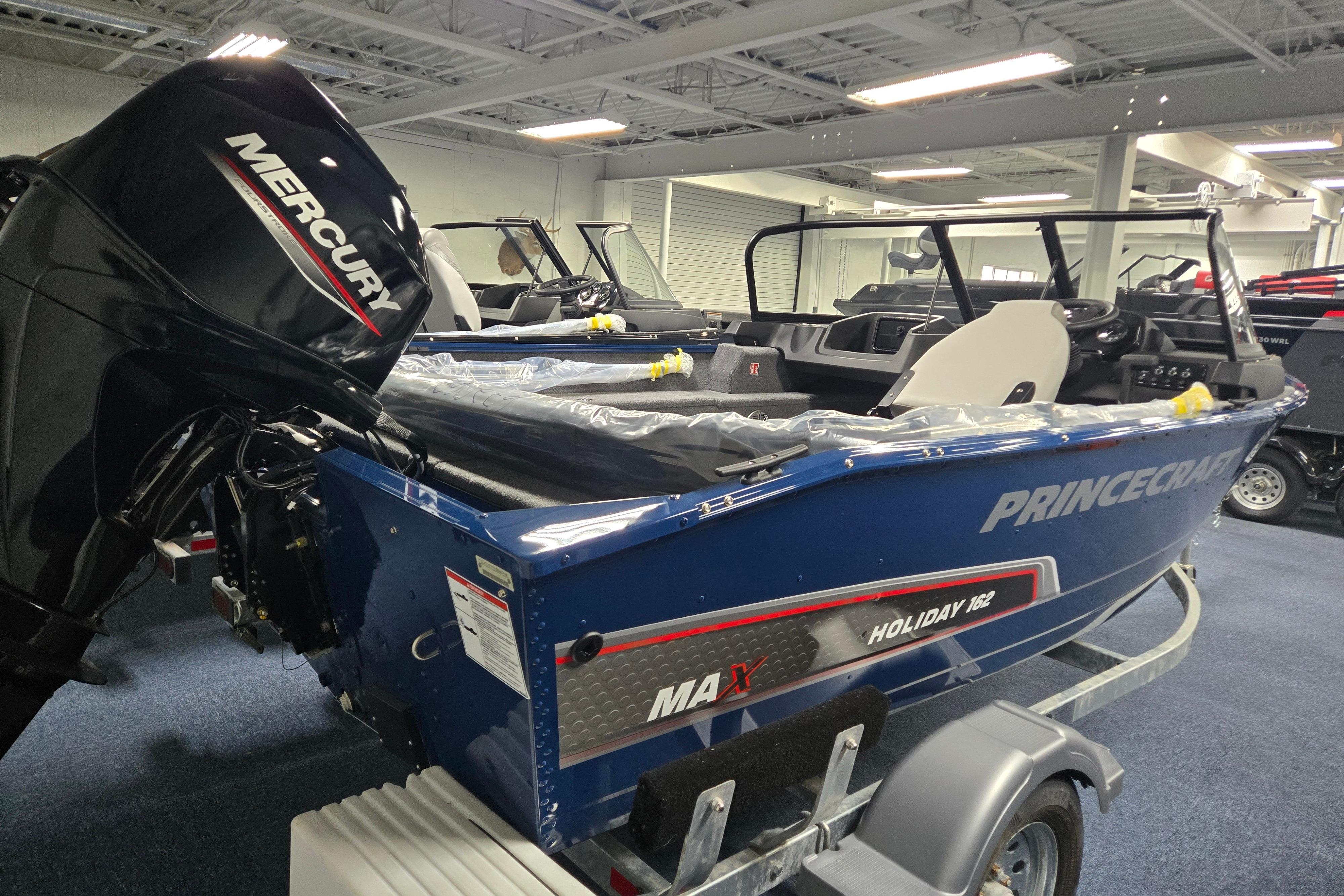 2026 Princecraft Holiday 162 WS MAX boat with Mercury engine in showroom.