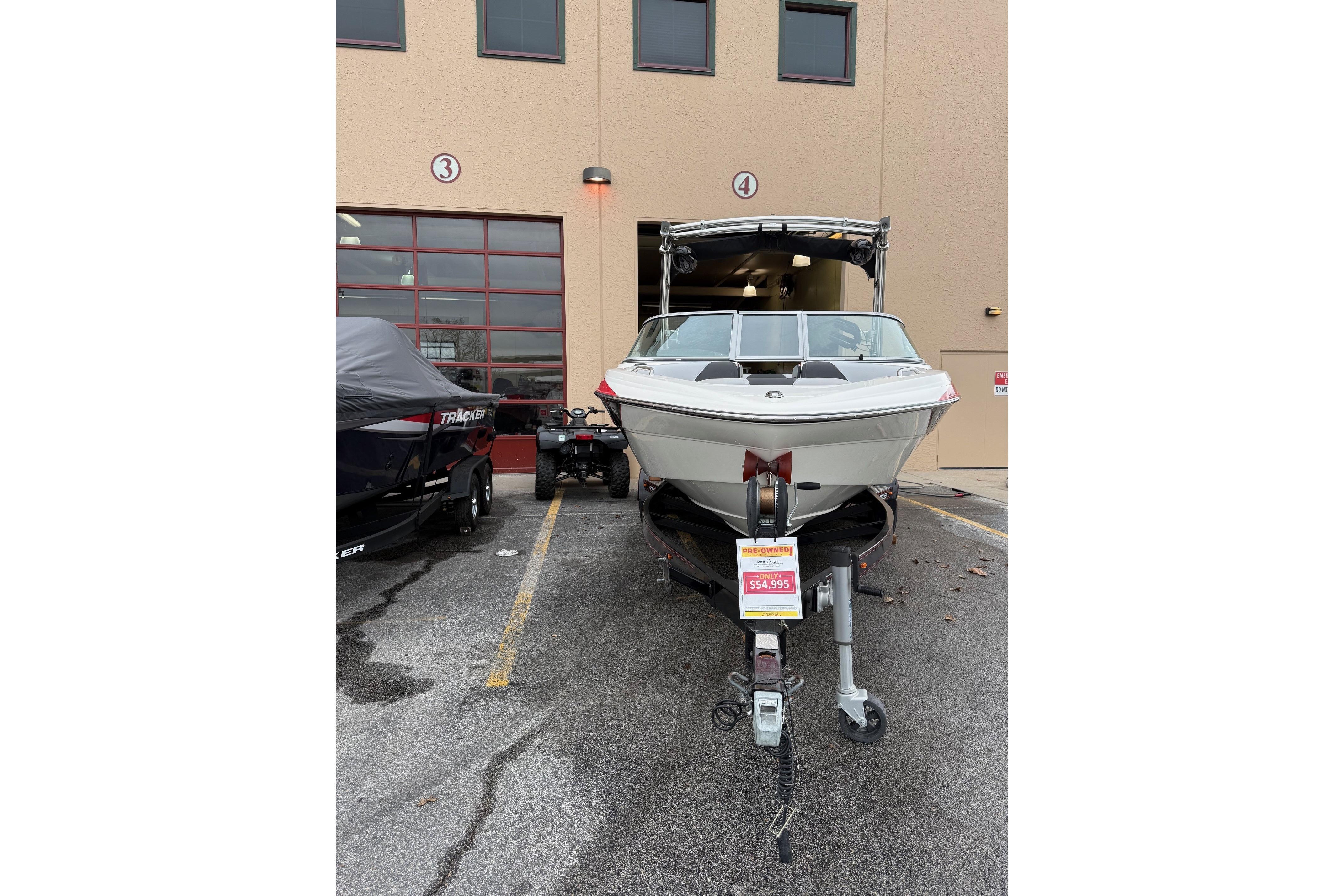 2014 MBSPORTS B523 23V boat on trailer, parked outside a building, priced at $54,995.
