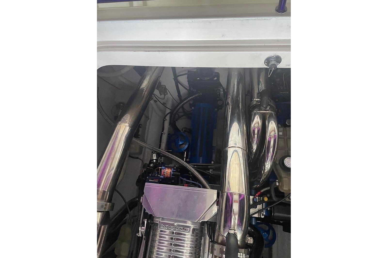 Engine compartment of a 2004 Fountain 38 Lightning boat, featuring polished components.