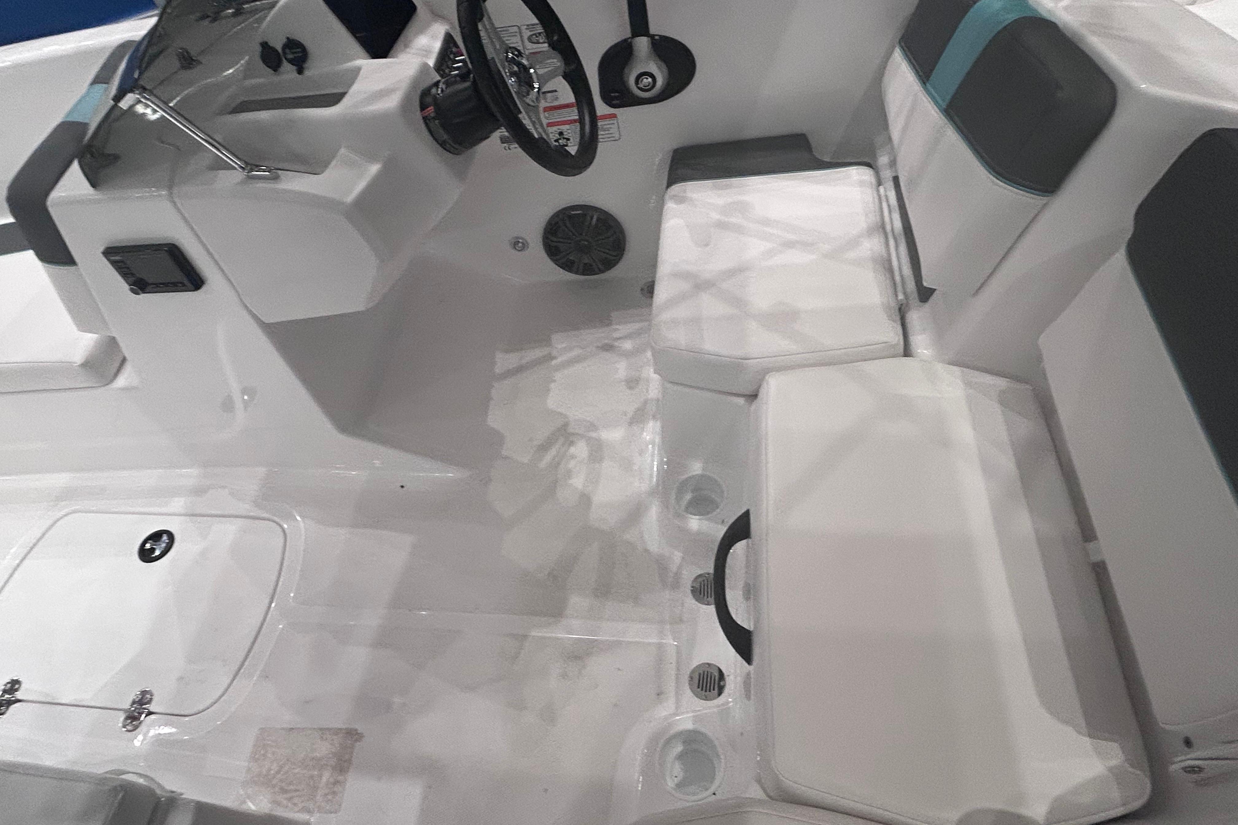 2026 Tahoe T18 boat interior with steering wheel, seating, and storage compartments.