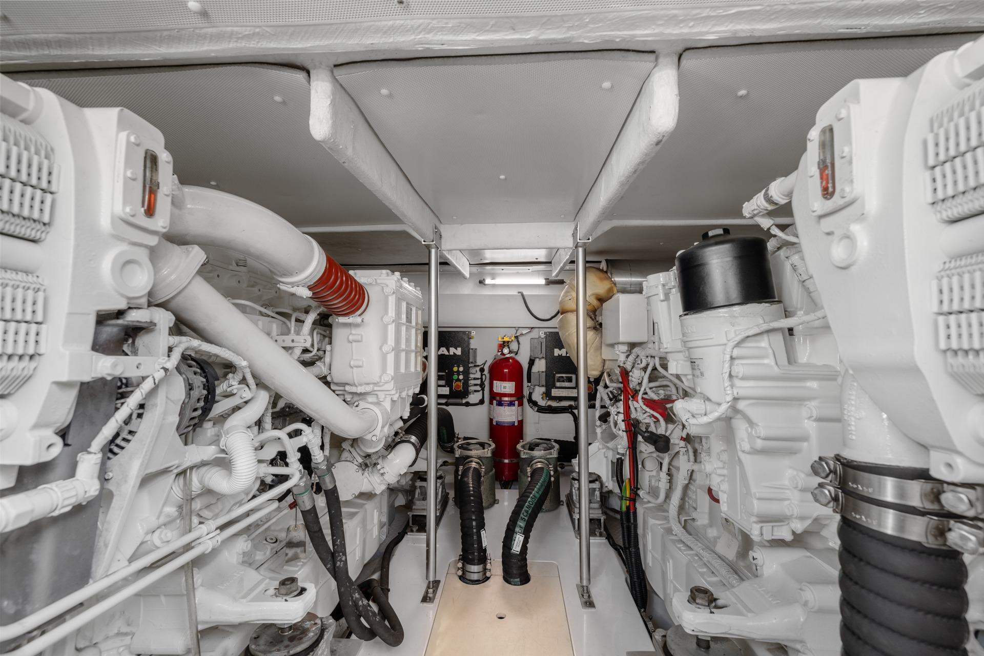 Engine room of a 2019 Azimut 55 yacht, featuring dual engines and fire suppression system.