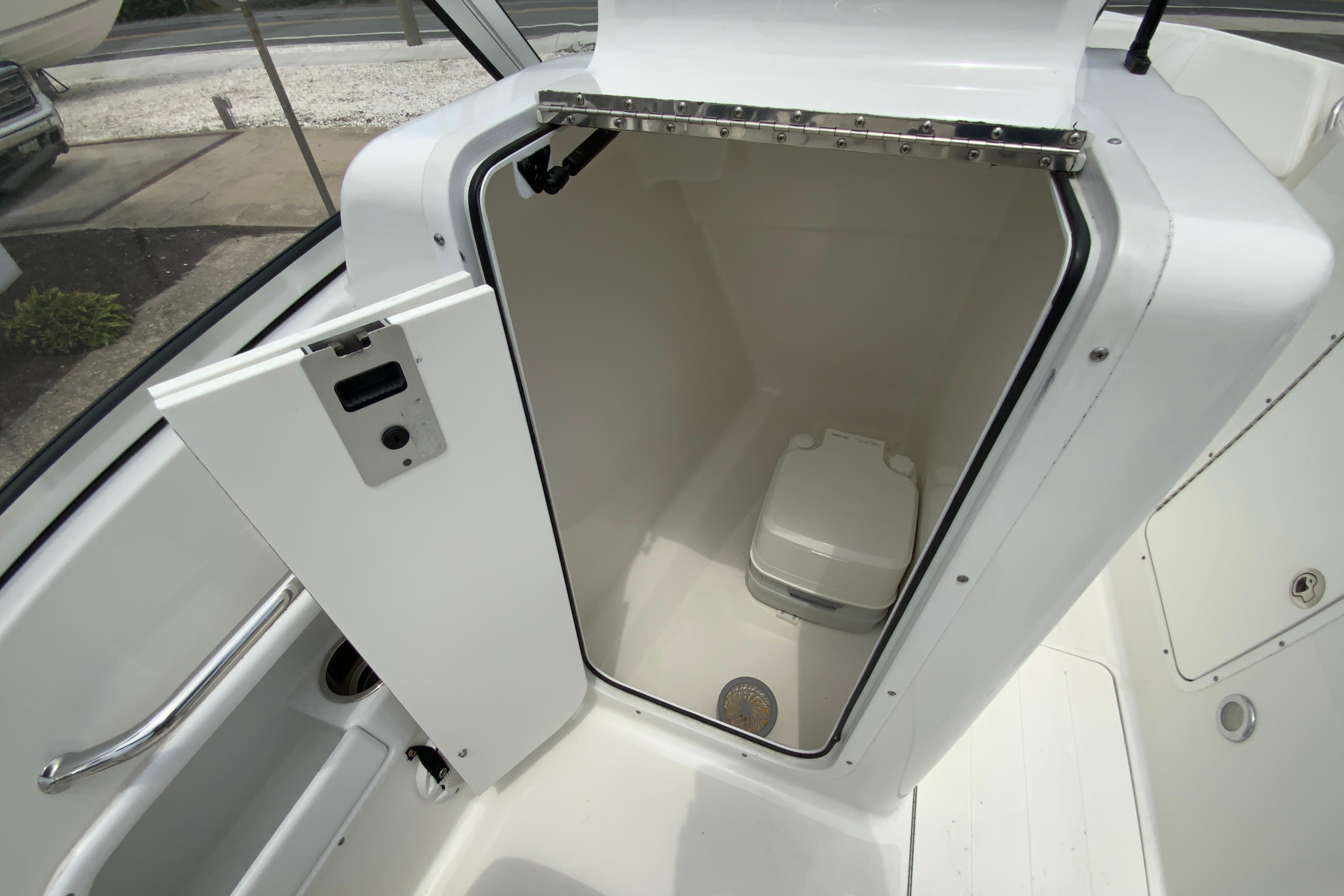 2014 Sea Hunt Escape 211 LE boat cabin with compact toilet.