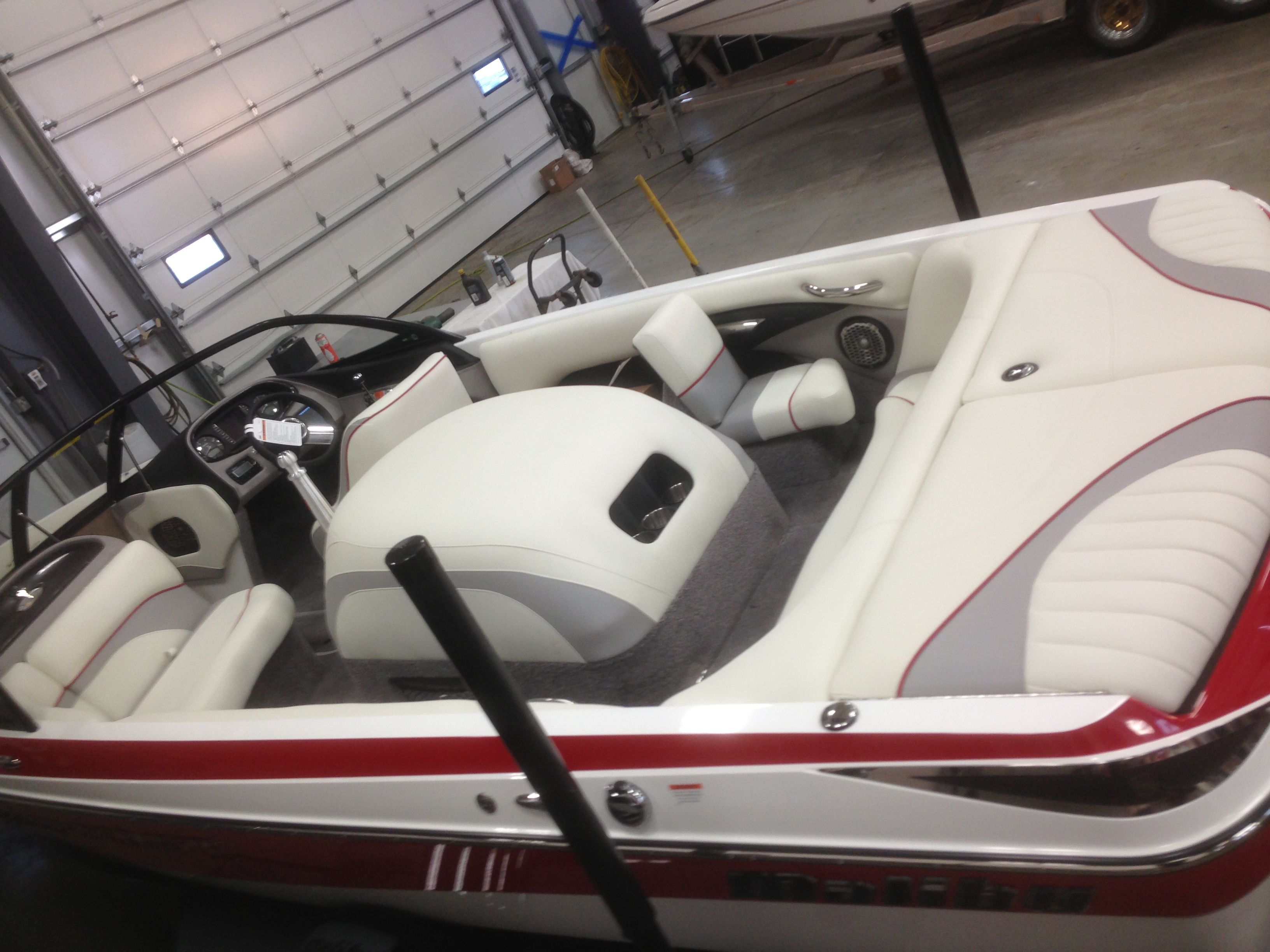 Interior of a 2014 Malibu Response TXi boat in a garage.