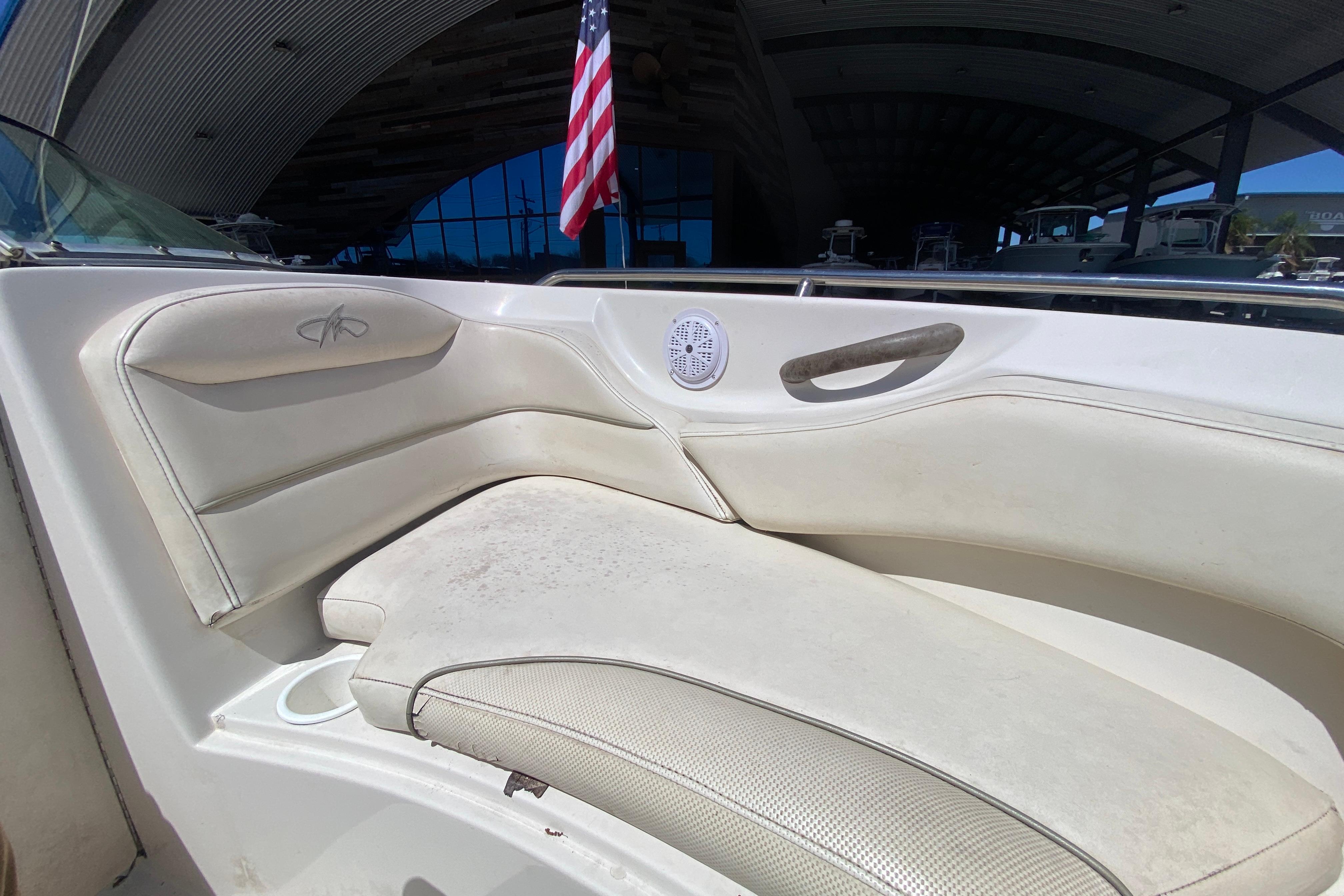 2003 Monterey 208SI Montura boat interior with white seating and American flag.
