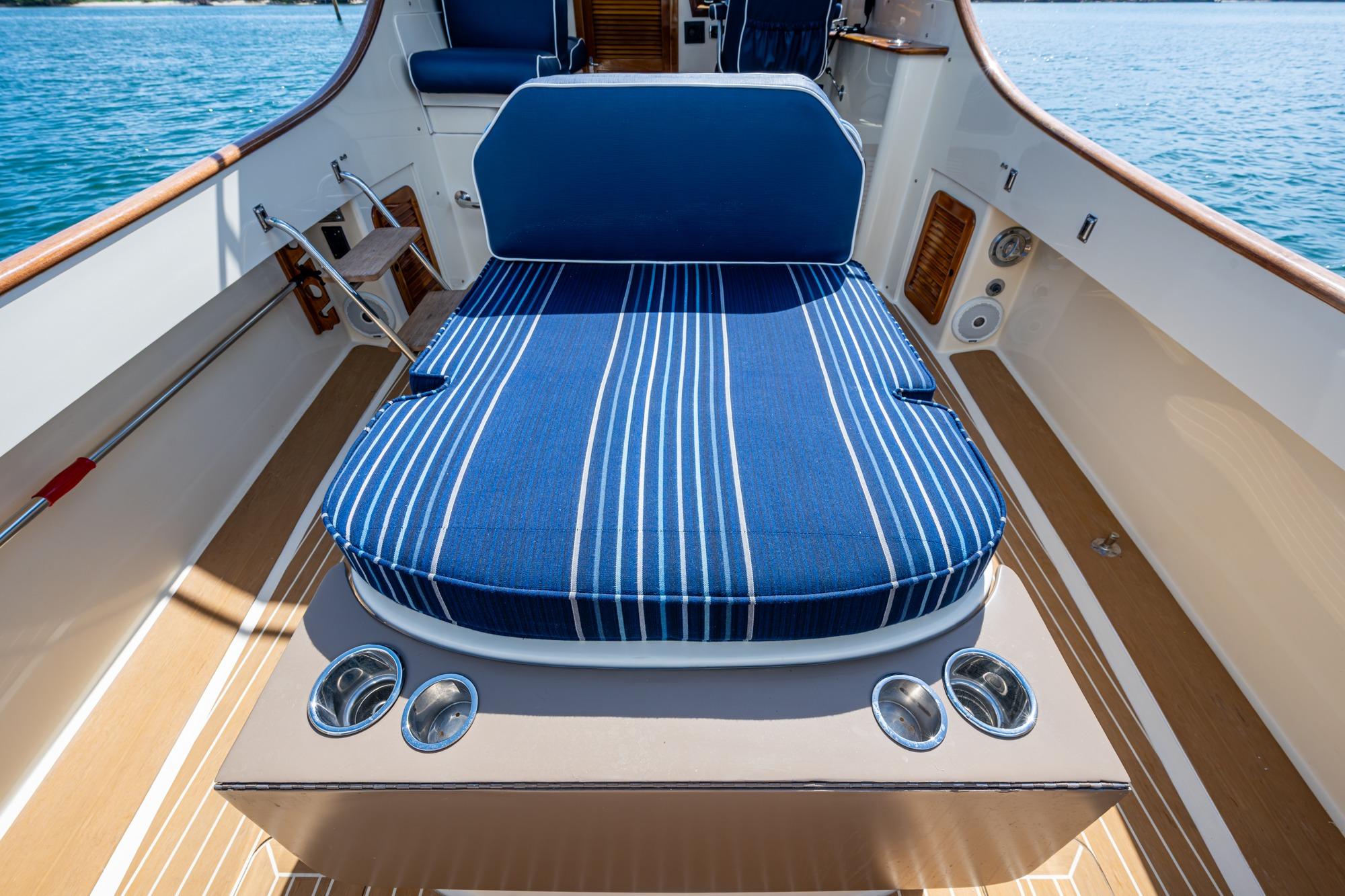 2001 Hinckley Picnic Boat Classic with blue striped seating on deck, ocean view.