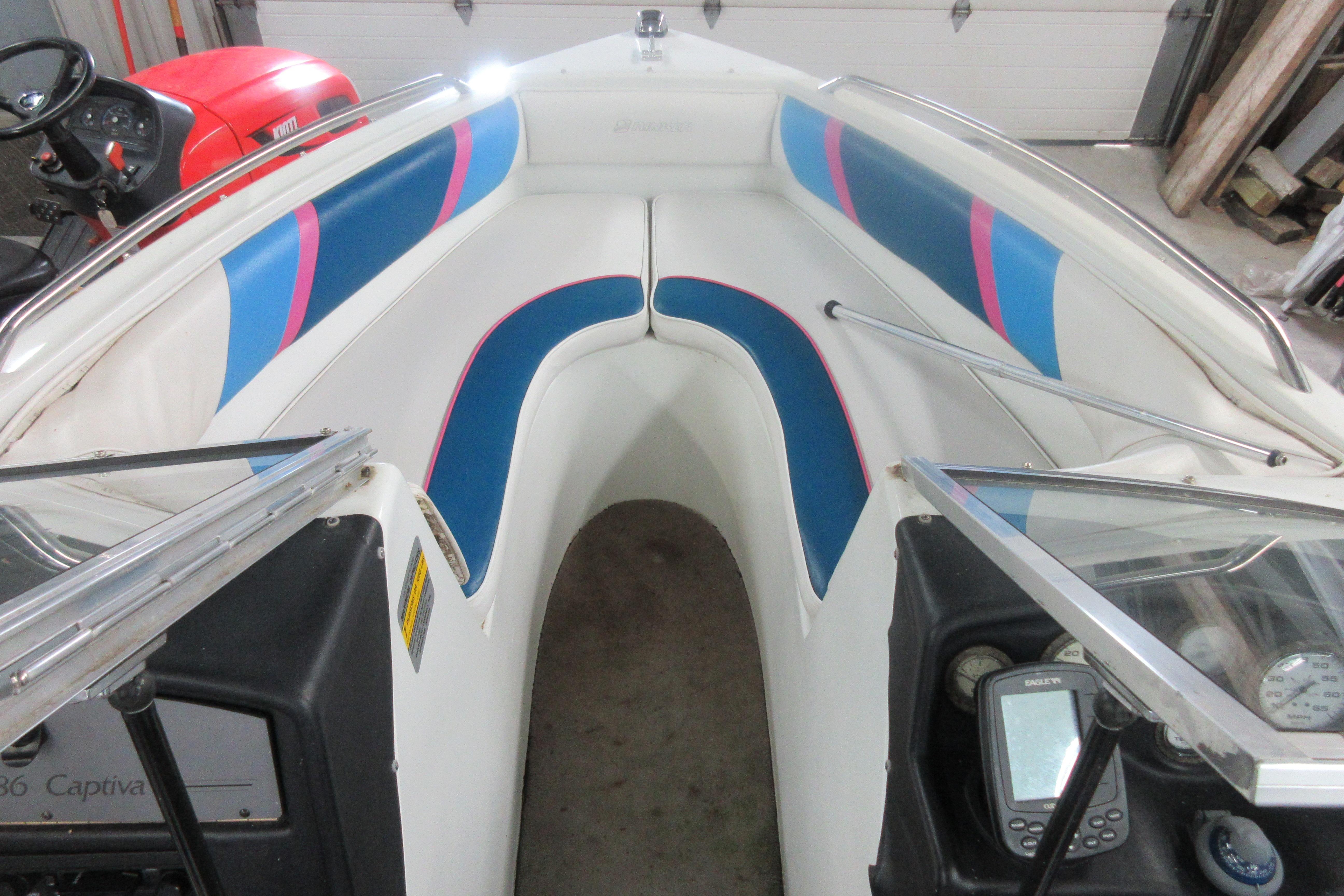 1993 Rinker 186 Captiva Bowrider interior with colorful seating and dashboard controls.