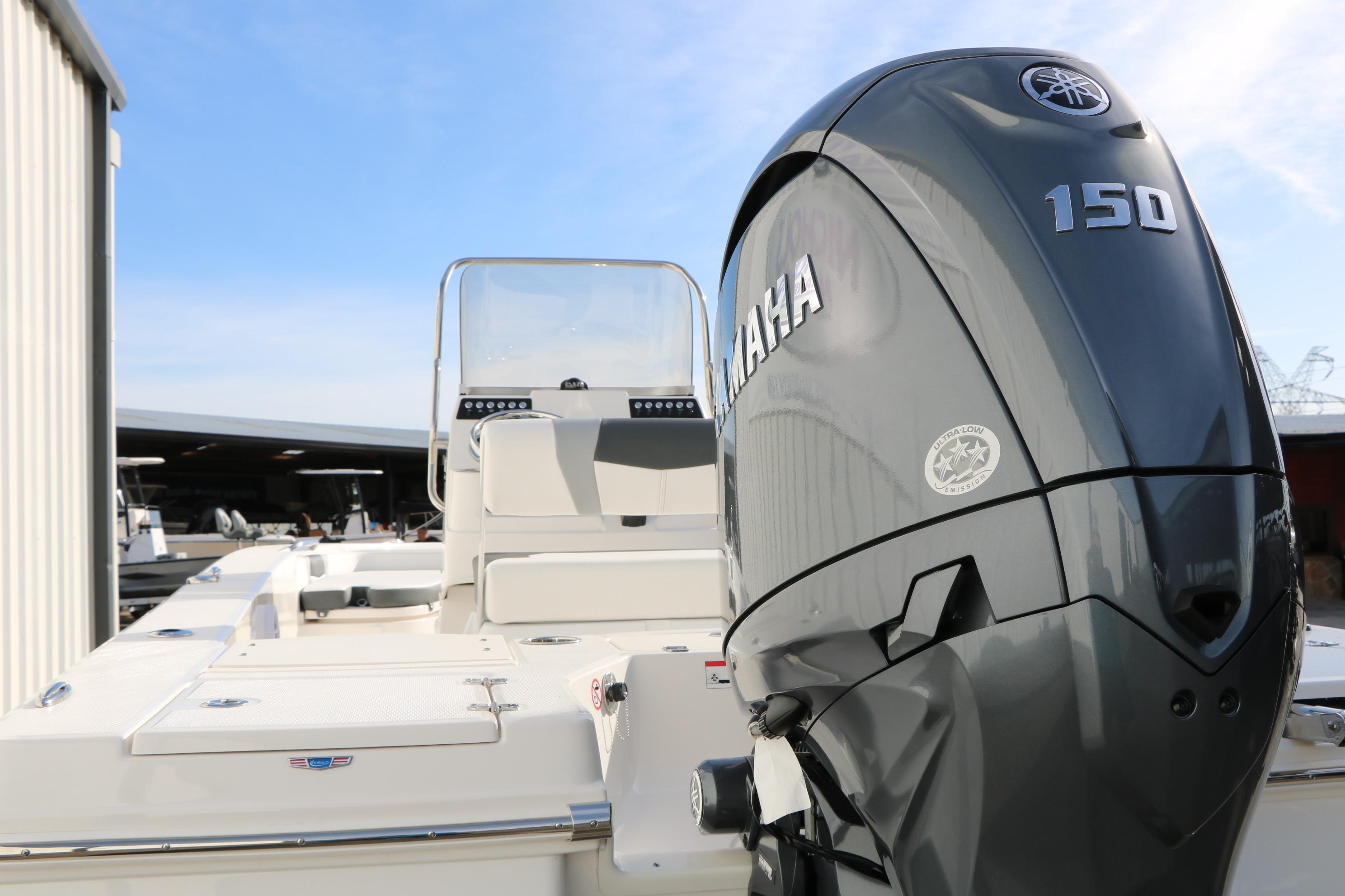 2026 Robalo 206 Cayman boat with Yamaha 150 engine, docked outdoors.