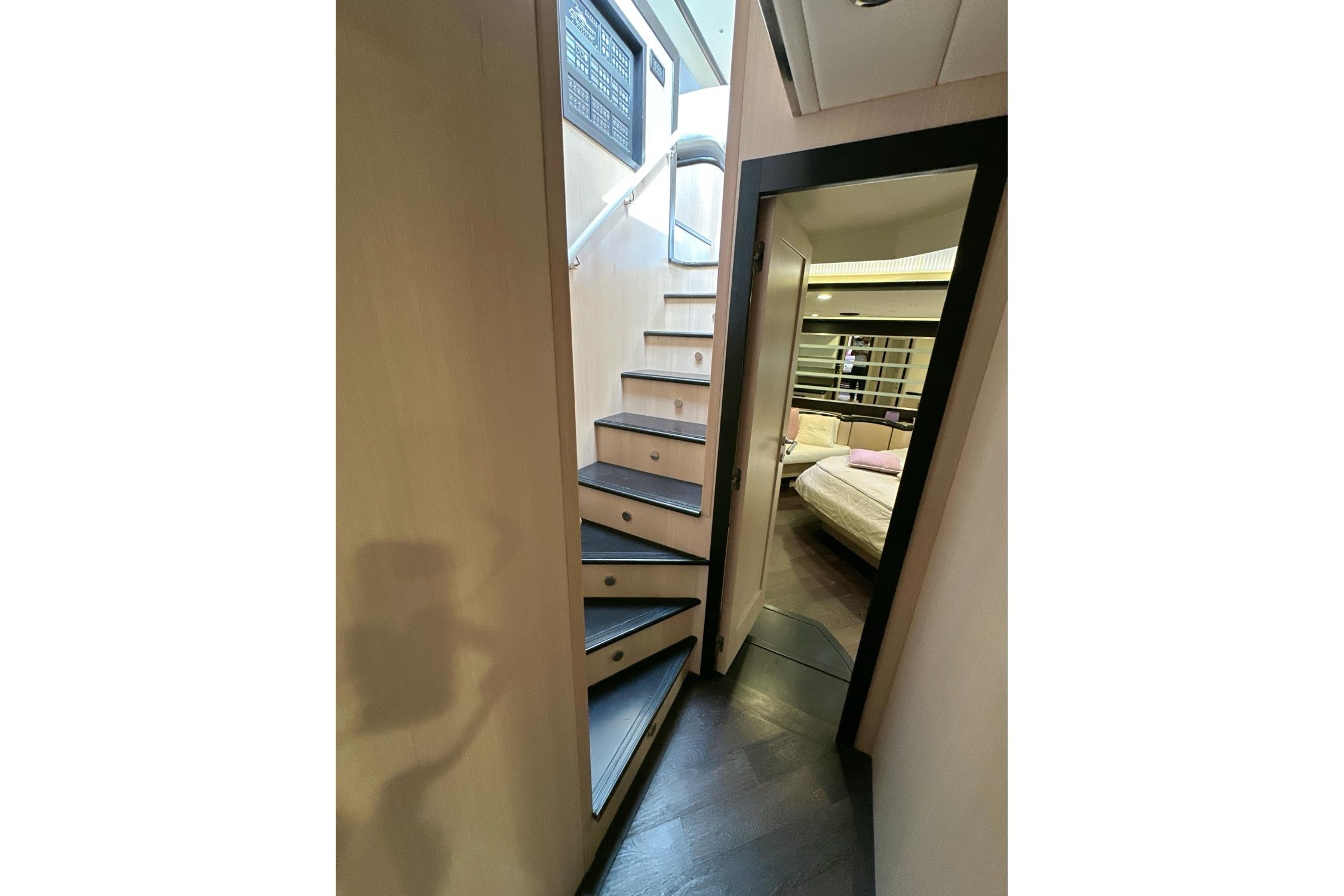 Interior view of 2010 Abati Yachts 64 Freeport, featuring stairs and a cozy bedroom.