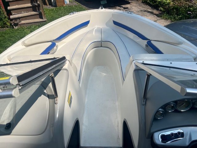 The image shows the interior of a Bayliner 185 boat with blue seating.