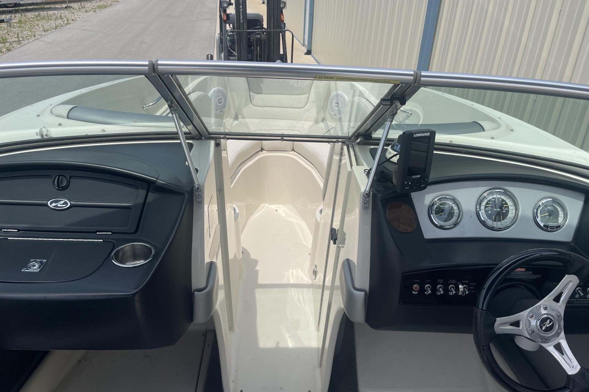 2010 Sea Ray 230 Bow Rider Select dashboard with steering wheel and gauges.
