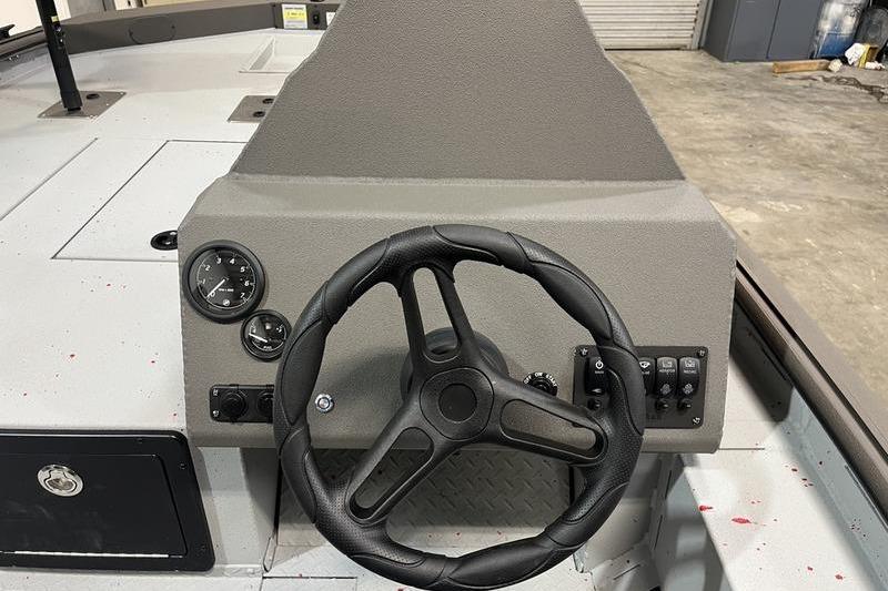 Steering console of 2026 SeaArk Flex 19 Pro boat, featuring gauges and controls.