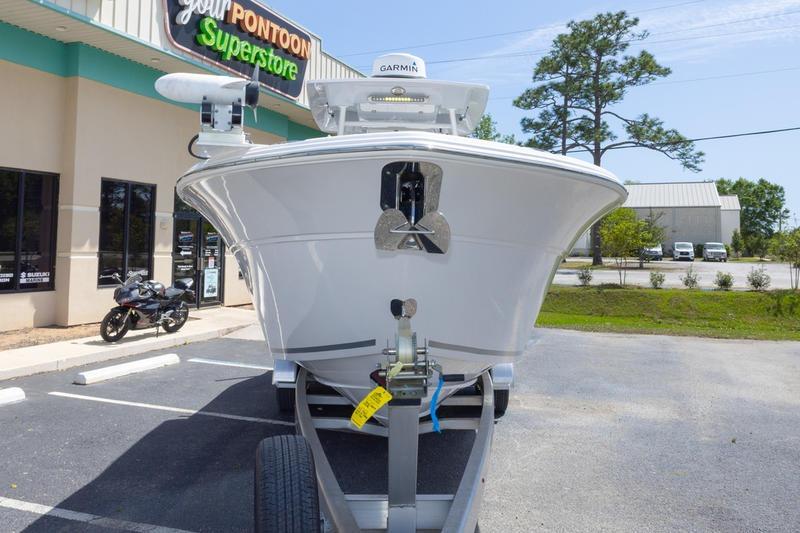 2023 Sea Fox 288 Commander boat on trailer at dealership parking lot.