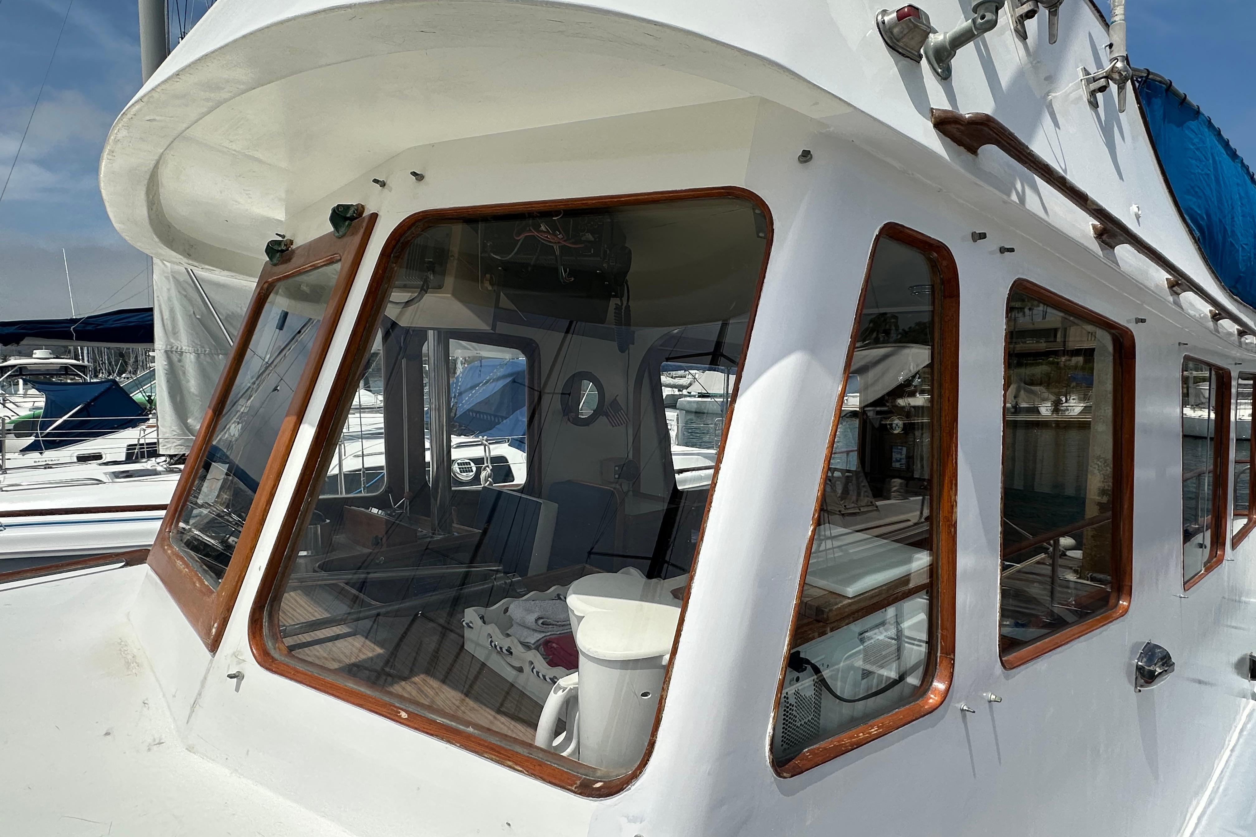 1973 CHB 33 boat with wooden-framed windows docked at a marina.