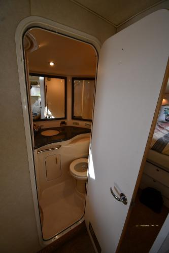 Bathroom interior of 1997 Sea Ray 400 Sundancer yacht, featuring sink and toilet.
