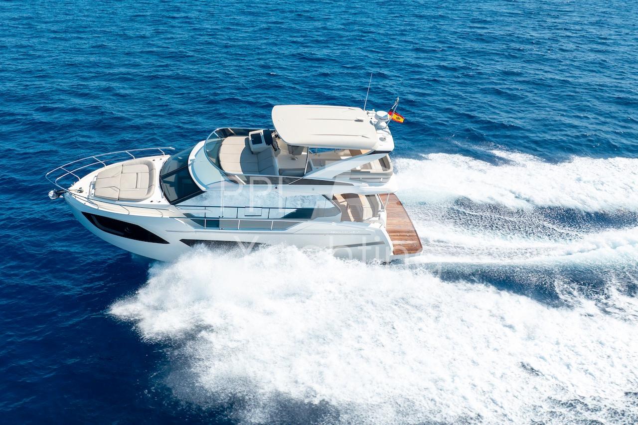 Luxury Absolute 47 Fly yacht cruising on open sea, 2021 model.