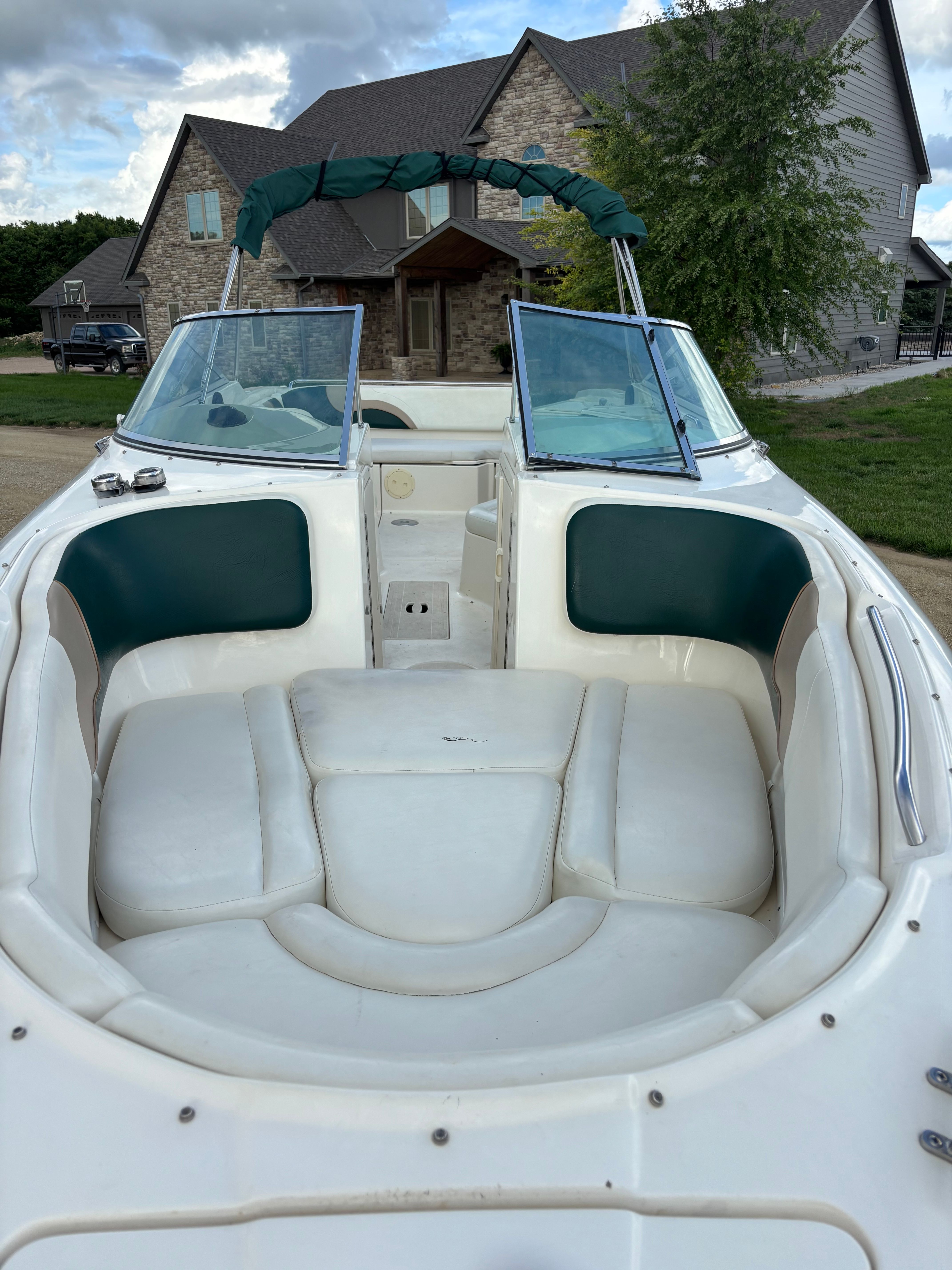 Interior view of a 1999 Rinker Captiva 272 boat near a house.