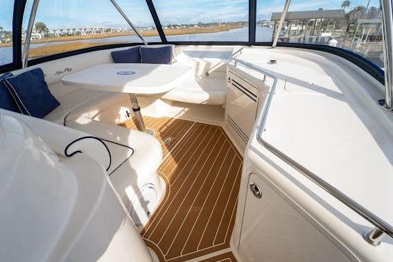 Luxurious 2006 Sea Ray 580 Sedan Bridge interior with elegant seating and wooden flooring.