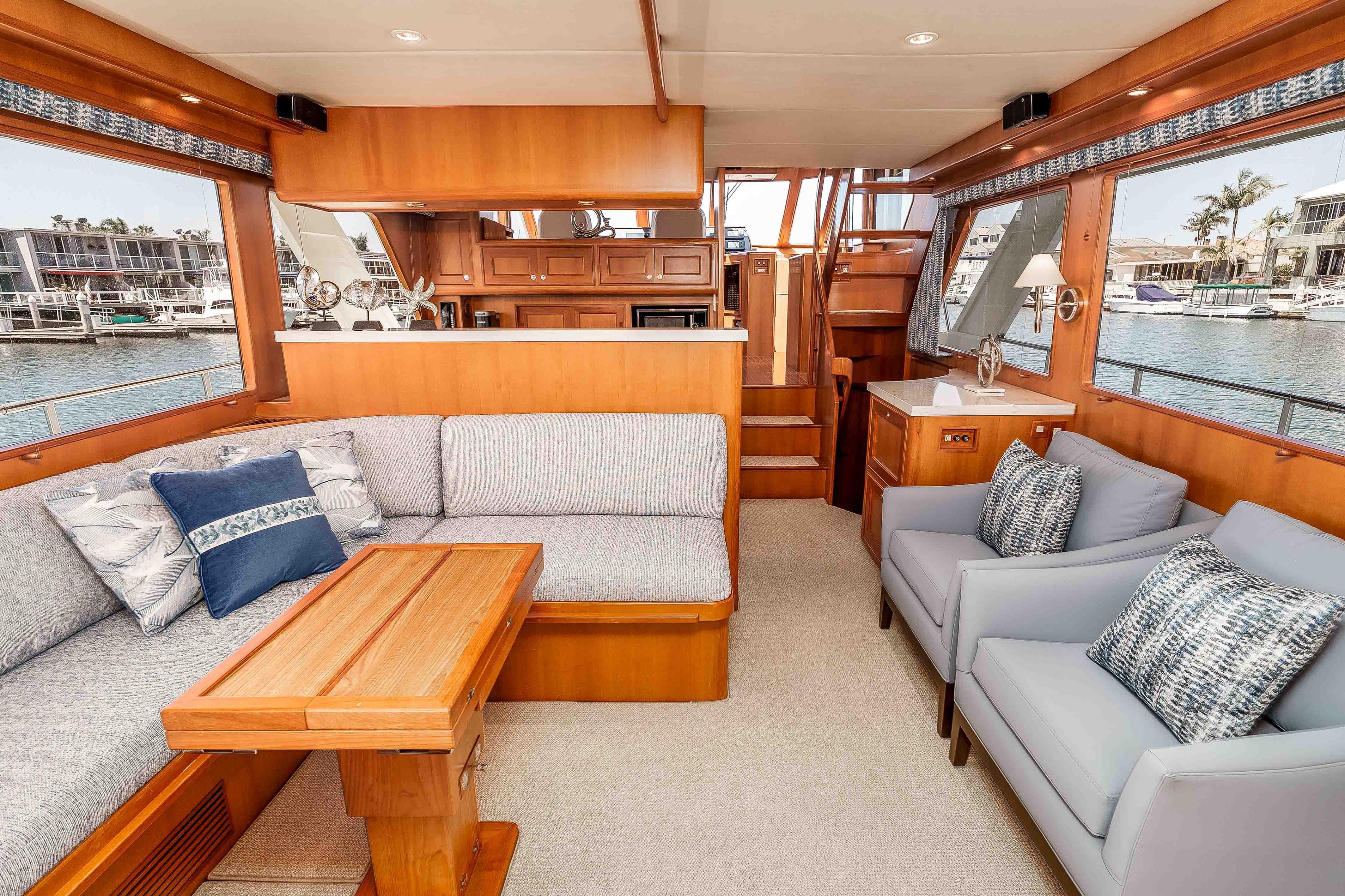 Luxurious interior of a 2005 Offshore Yachts 54 Pilothouse with elegant seating and wood finishes.