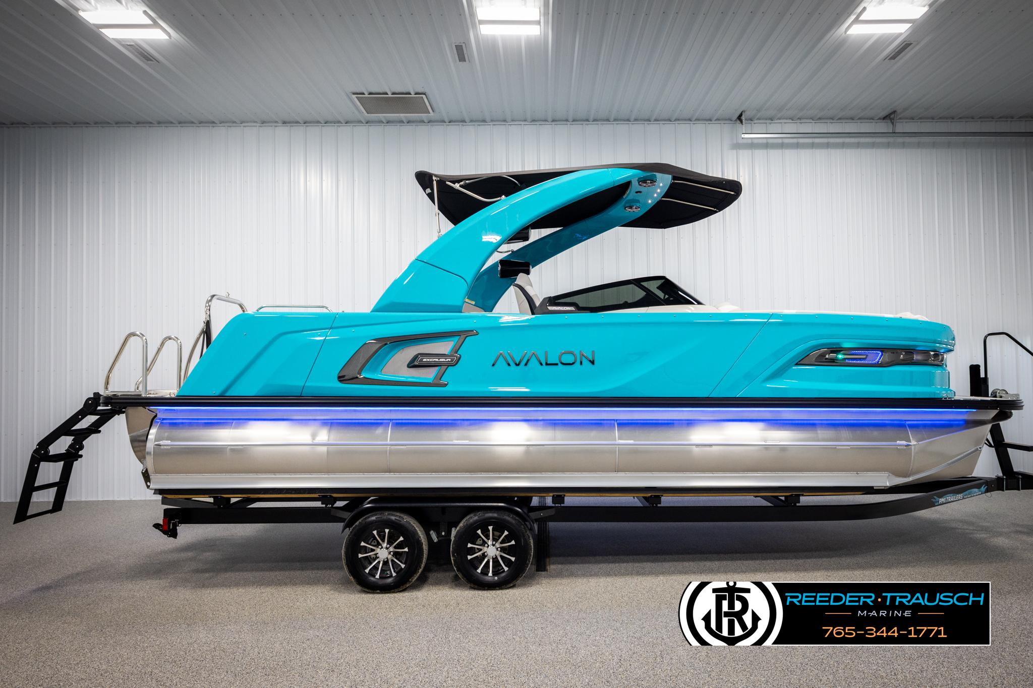 2025 Avalon 2585 Excal VRBW pontoon boat in a showroom, vibrant blue color.