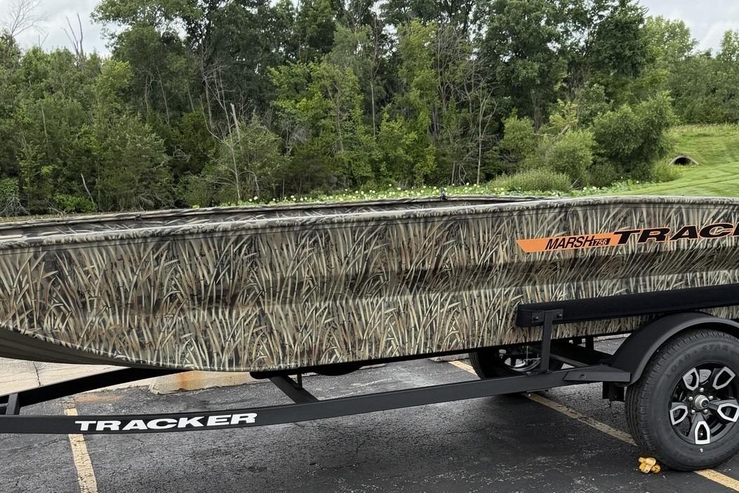 2026 Tracker Grizzly 1756 T Marsh boat with camouflage design on a trailer.