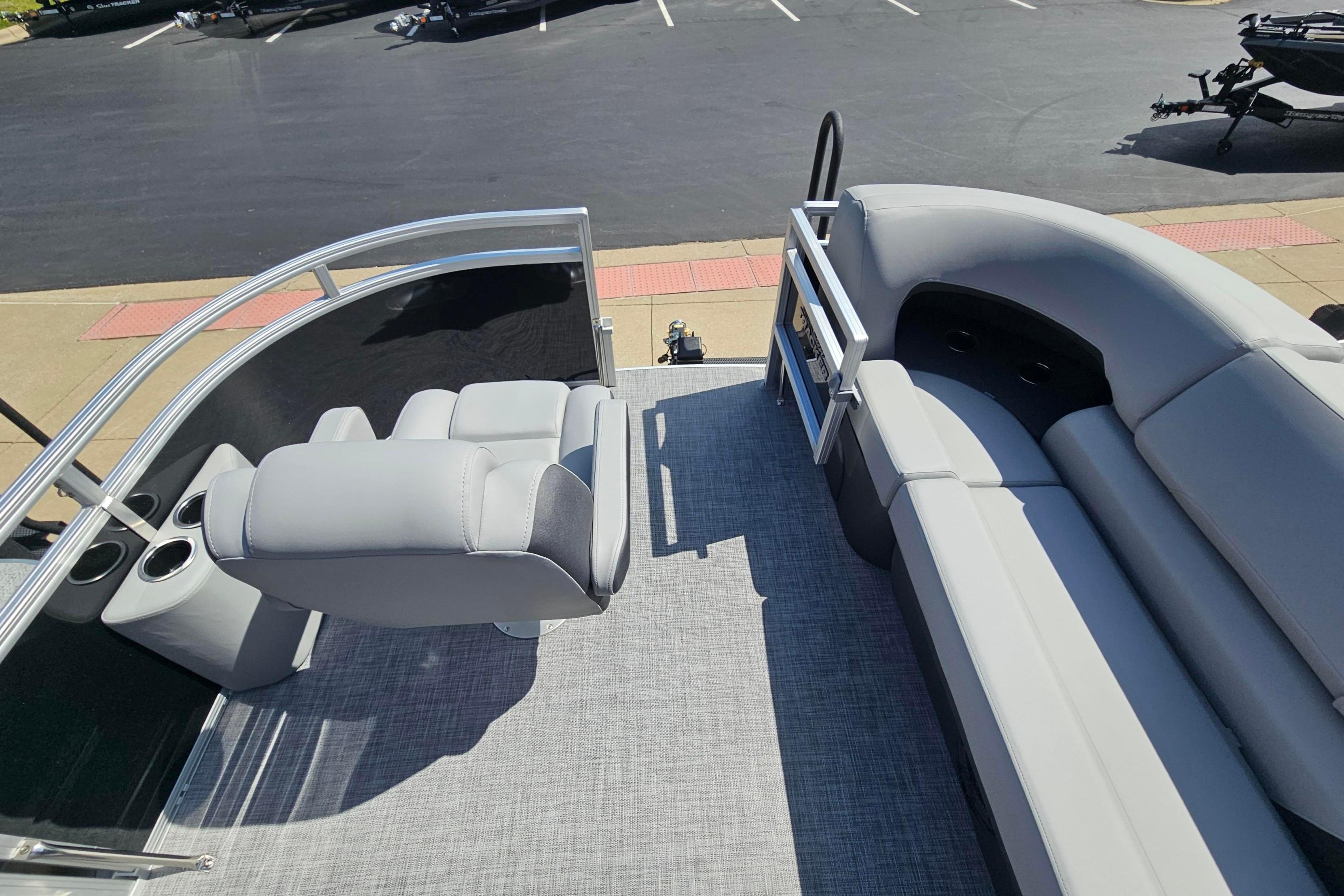 2026 Sun Tracker SportFish 20 DLX pontoon boat interior with seating and cup holders.