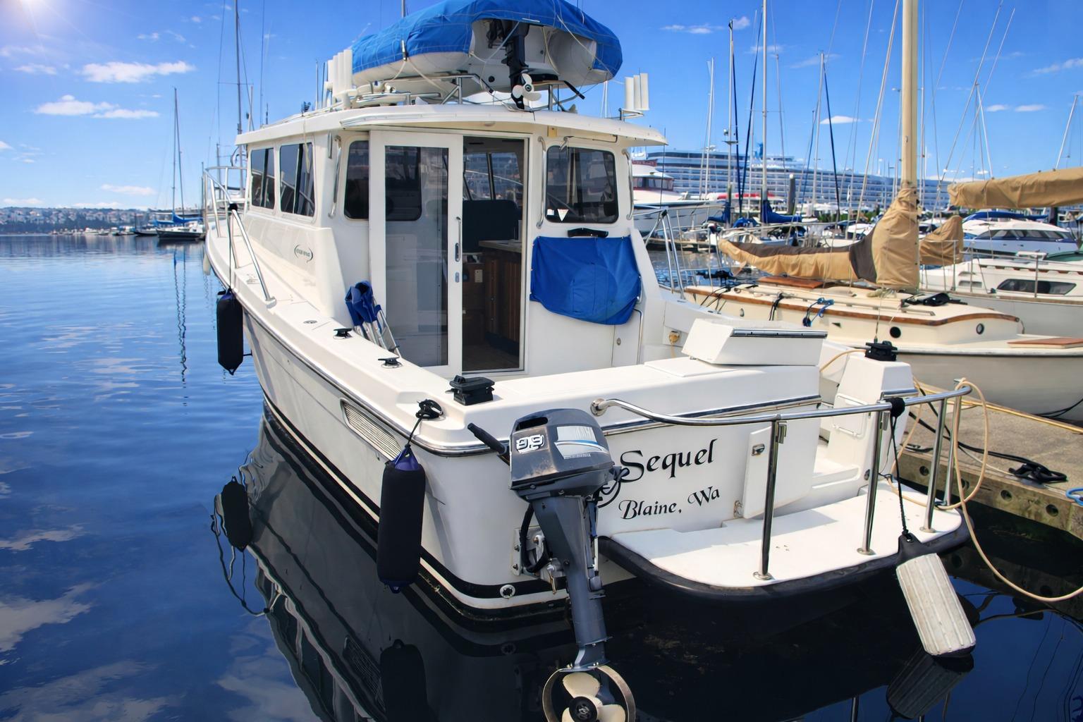 2005 Ocean Sport 30' boat docked in a marina under clear blue skies.