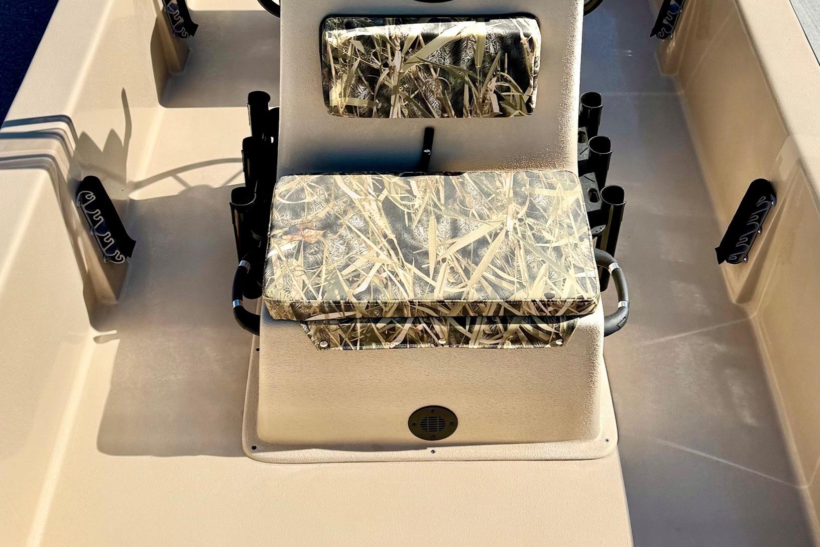 2026 Carolina Skiff E18 JVX CC boat interior with camo-patterned seating and rod holders.
