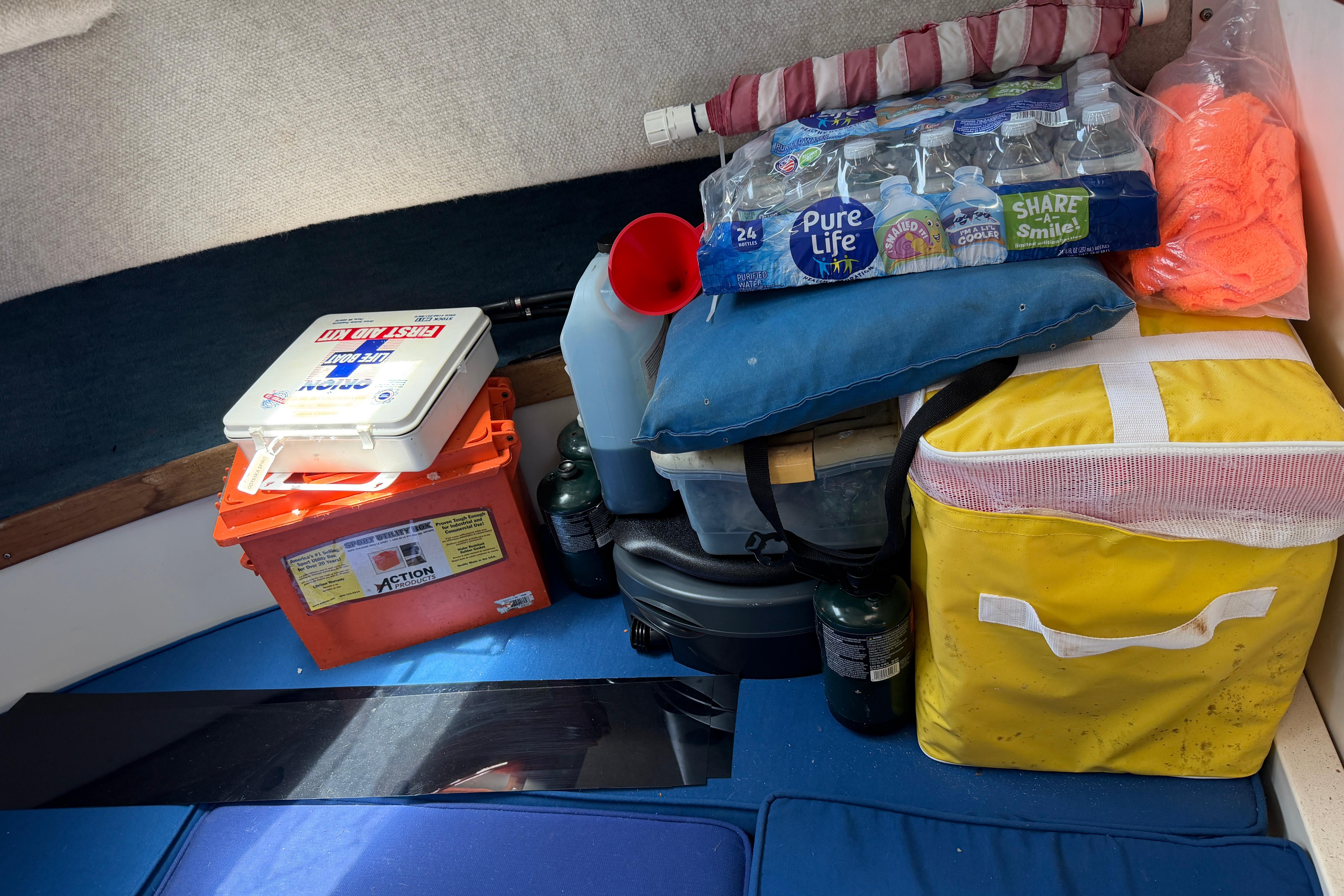 Interior of 1987 Grady-White Seafarer 226 with supplies and safety equipment.