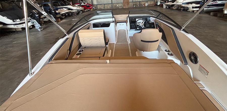 2025 Sea Ray SPX 190 Outboard boat interior with beige seating and modern dashboard.