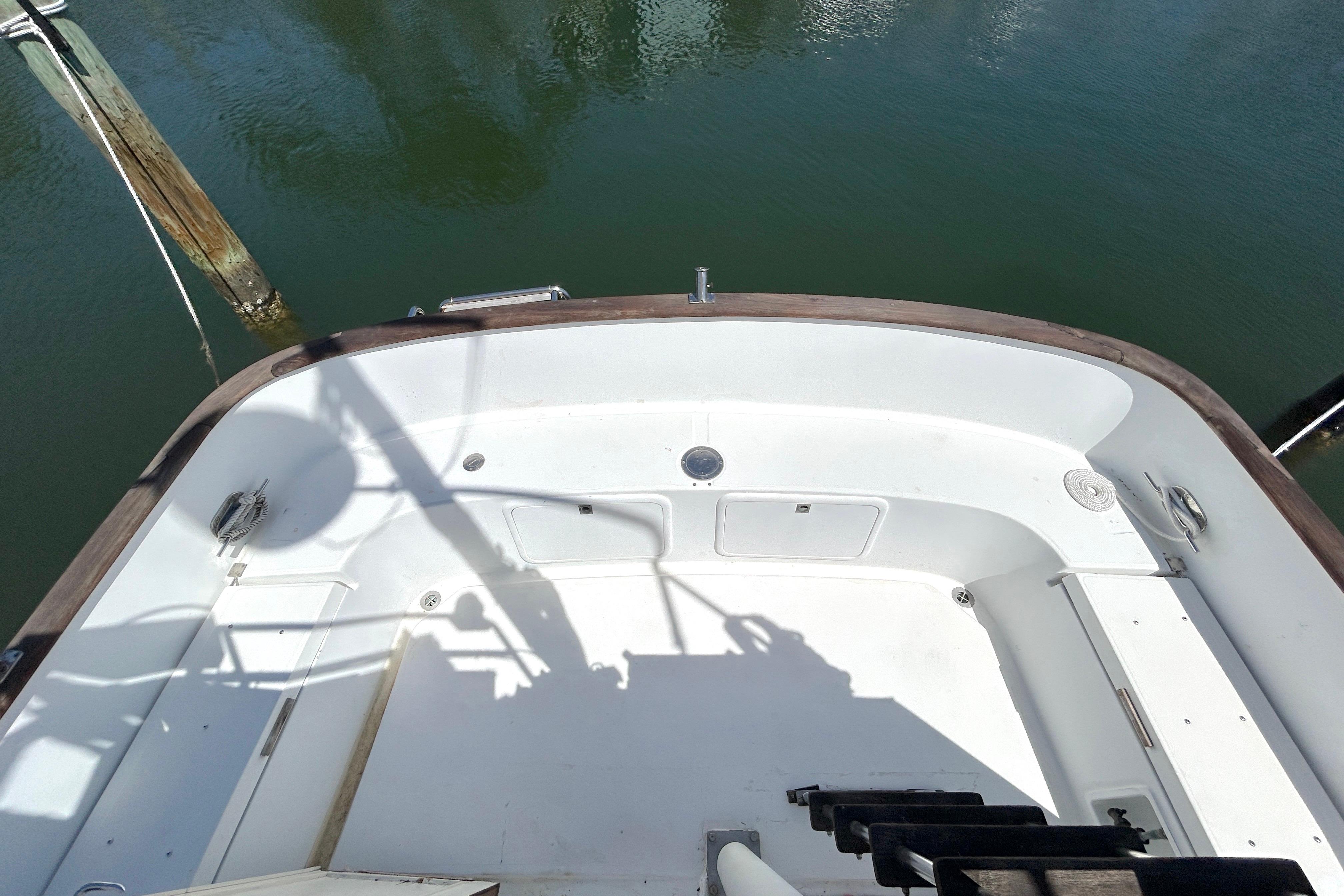 1987 Transpacific Marine Eagle 32 Trawler deck, featuring spacious white interior and wooden trim.