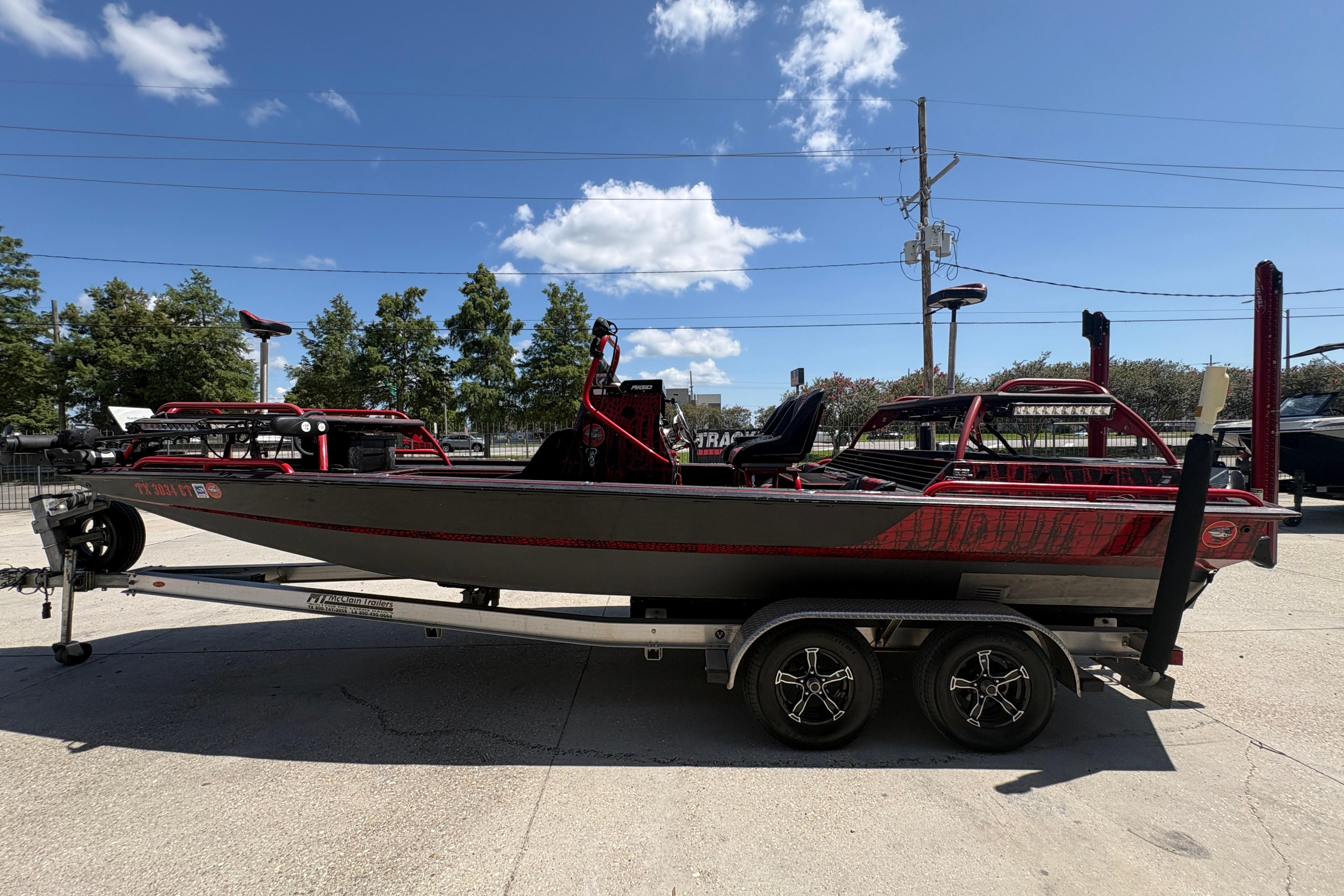 Custom 2018 Swamp Shark 24' boat on trailer under clear blue sky.