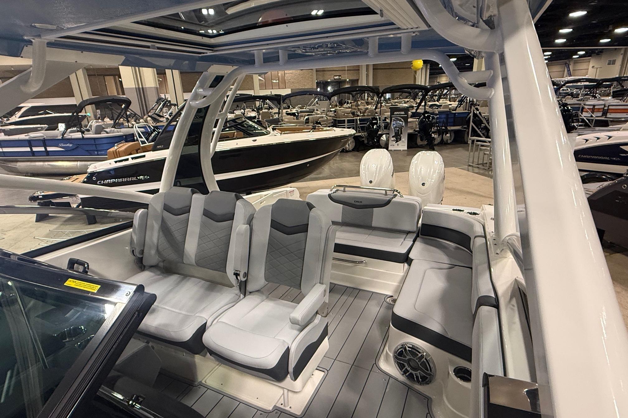 2026 Chaparral 280 OSX boat interior at a showroom, featuring sleek seating and modern design.