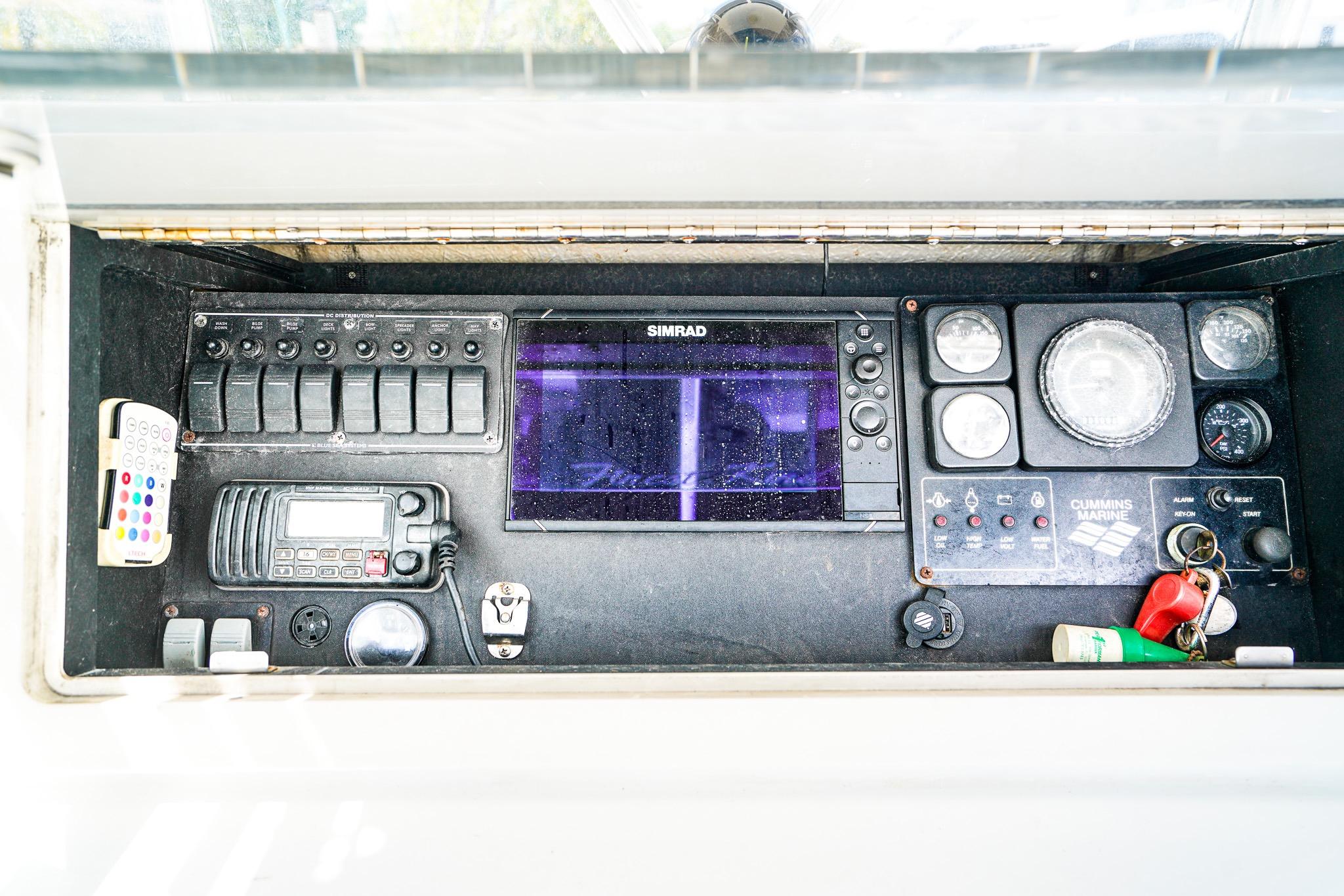 Control panel of a 1977 Scarborough 27 CC boat with navigation and communication equipment.