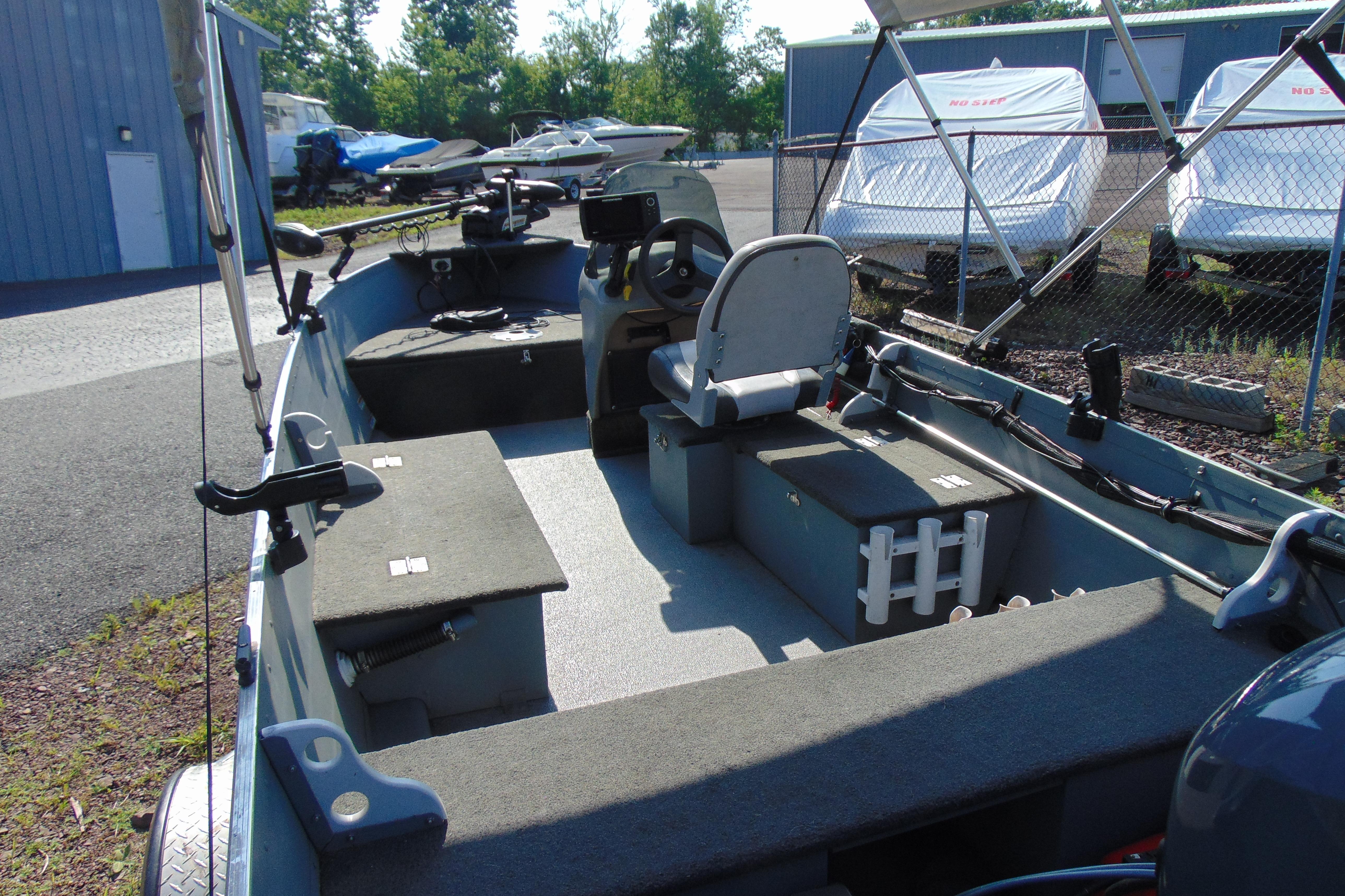 2017 Starcraft SF 16 DLX boat interior with seating and controls, parked outdoors.