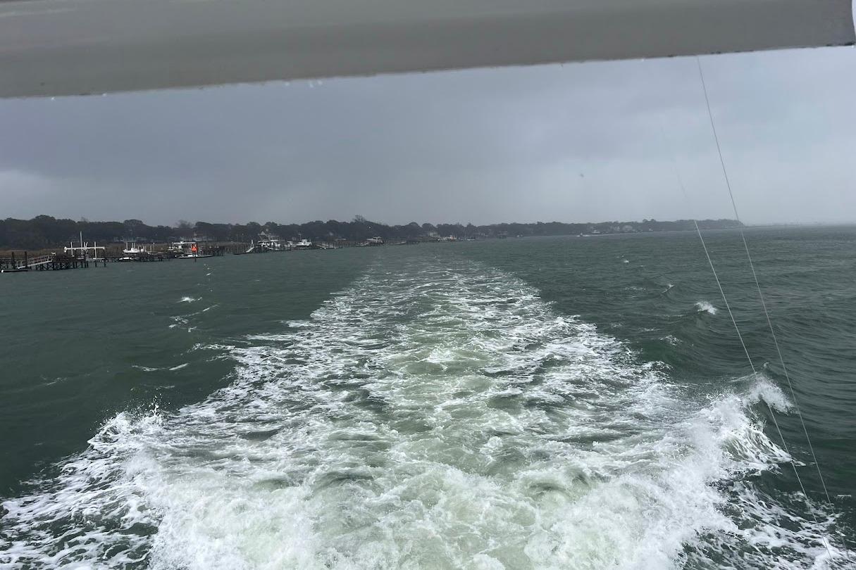 Wake of Ocean Yachts 48 Super Sport, 1996, cruising on a cloudy day.