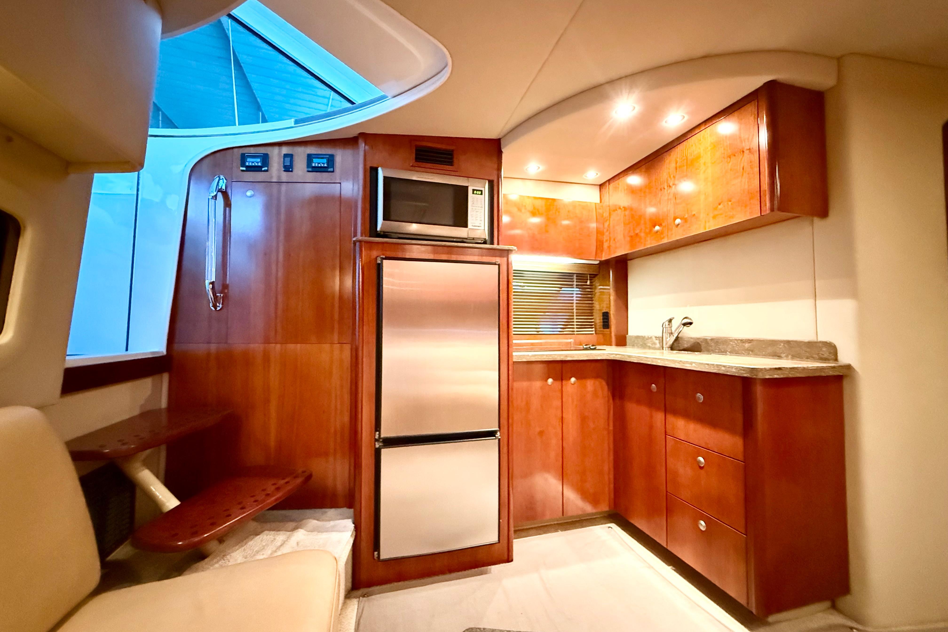 Luxurious interior of 2011 Cruisers Yachts 390 Sports Coupe with modern kitchen amenities.