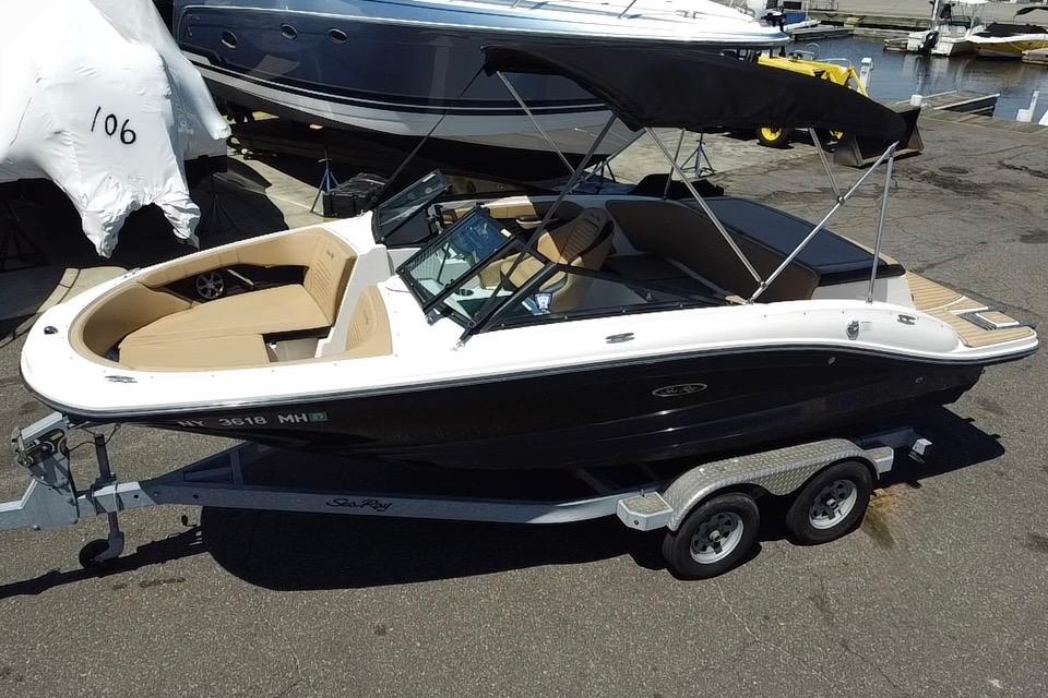 2021 Sea Ray SPX 190 boat on trailer, black hull, beige interior, dockside view.