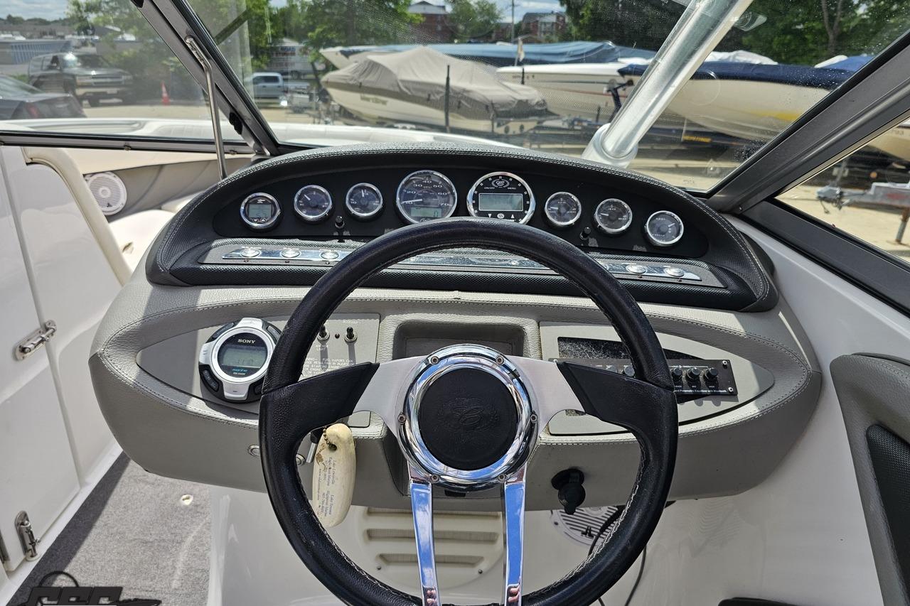Steering console of a 2010 Cobalt 232 WSS boat with gauges and controls.
