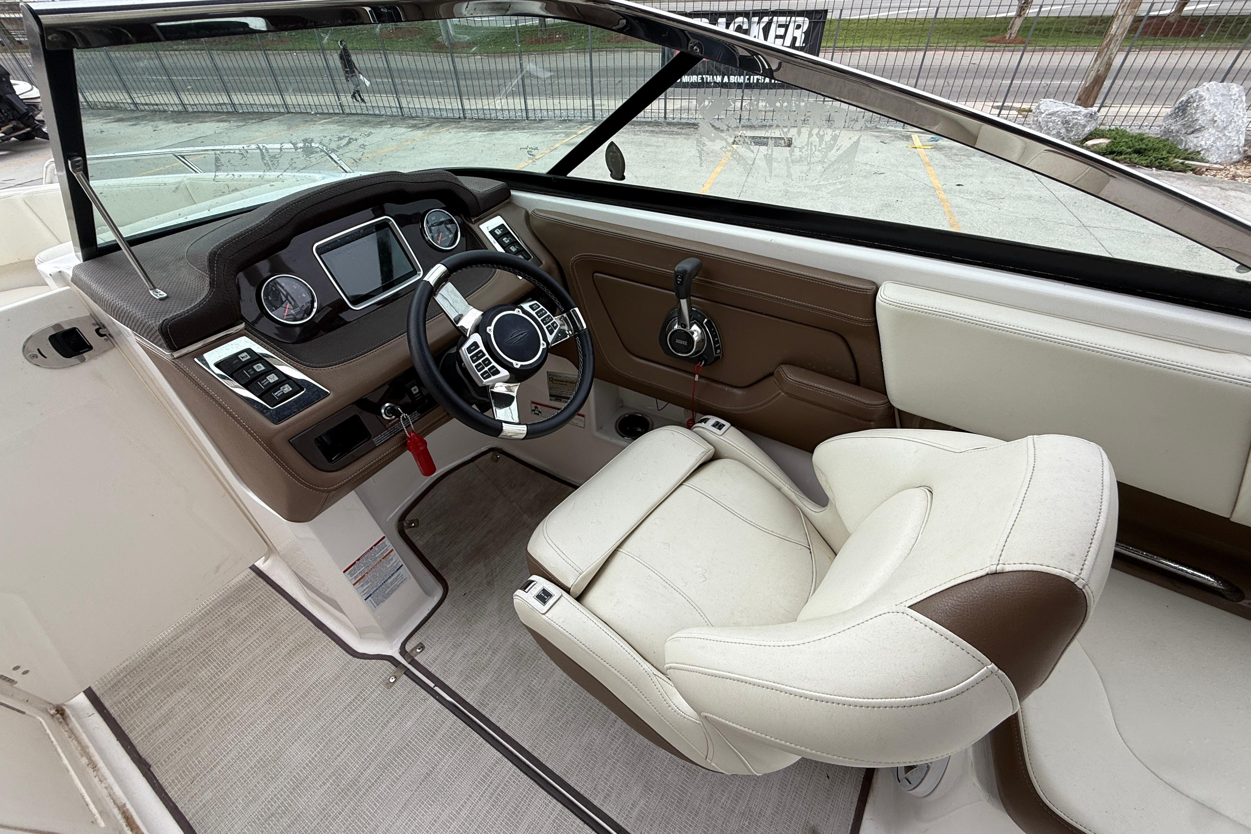 2018 Chaparral 227 SSX Surf boat cockpit with steering wheel and control panel.