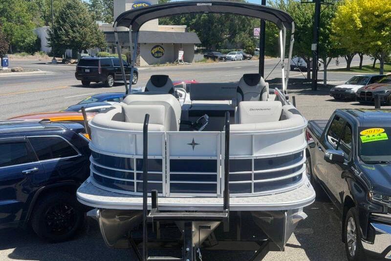 2026 Berkshire LE 24' Ultra Lounger boat displayed in a parking lot.