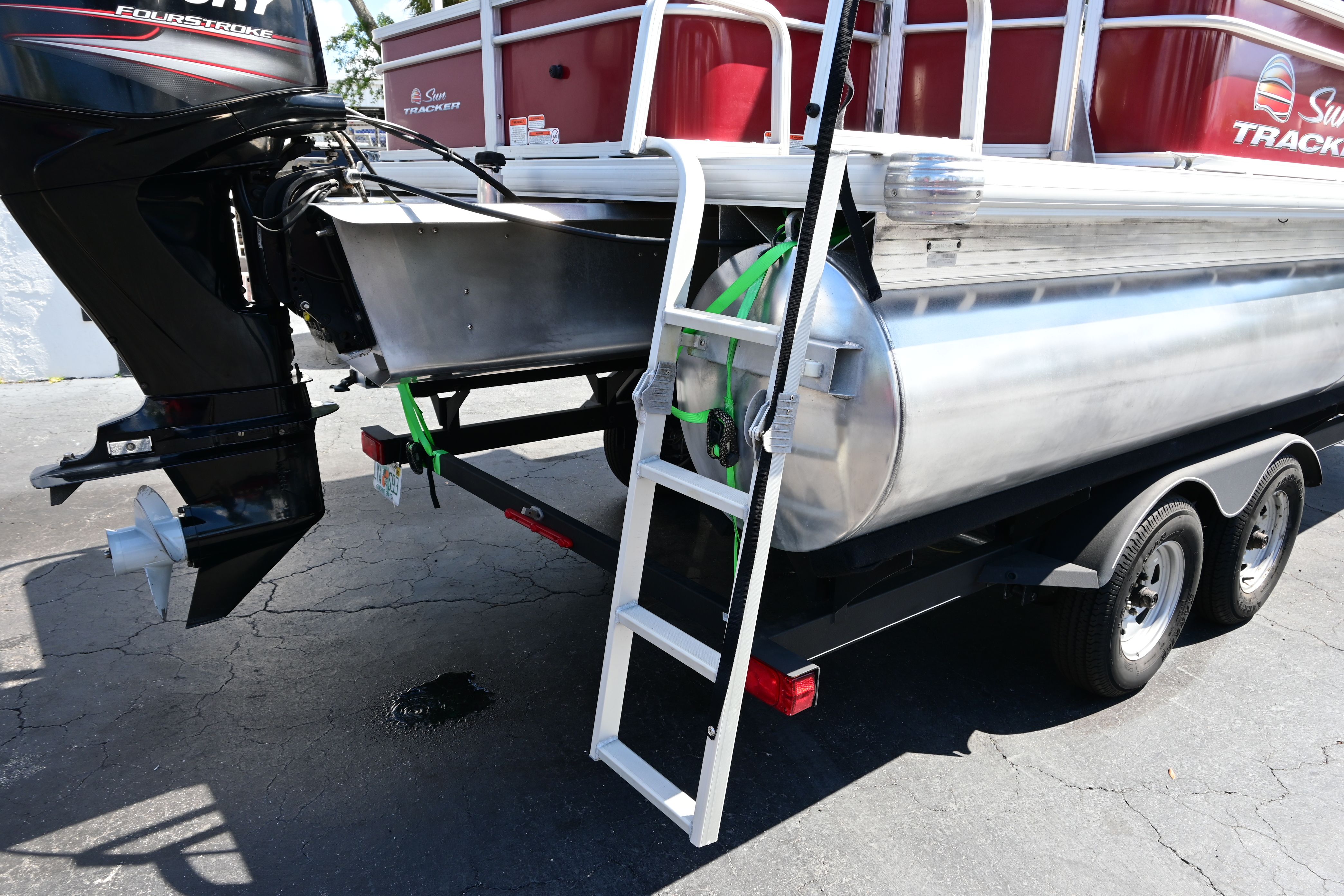2019 Sun Tracker FISHI pontoon boat with outboard motor and ladder.