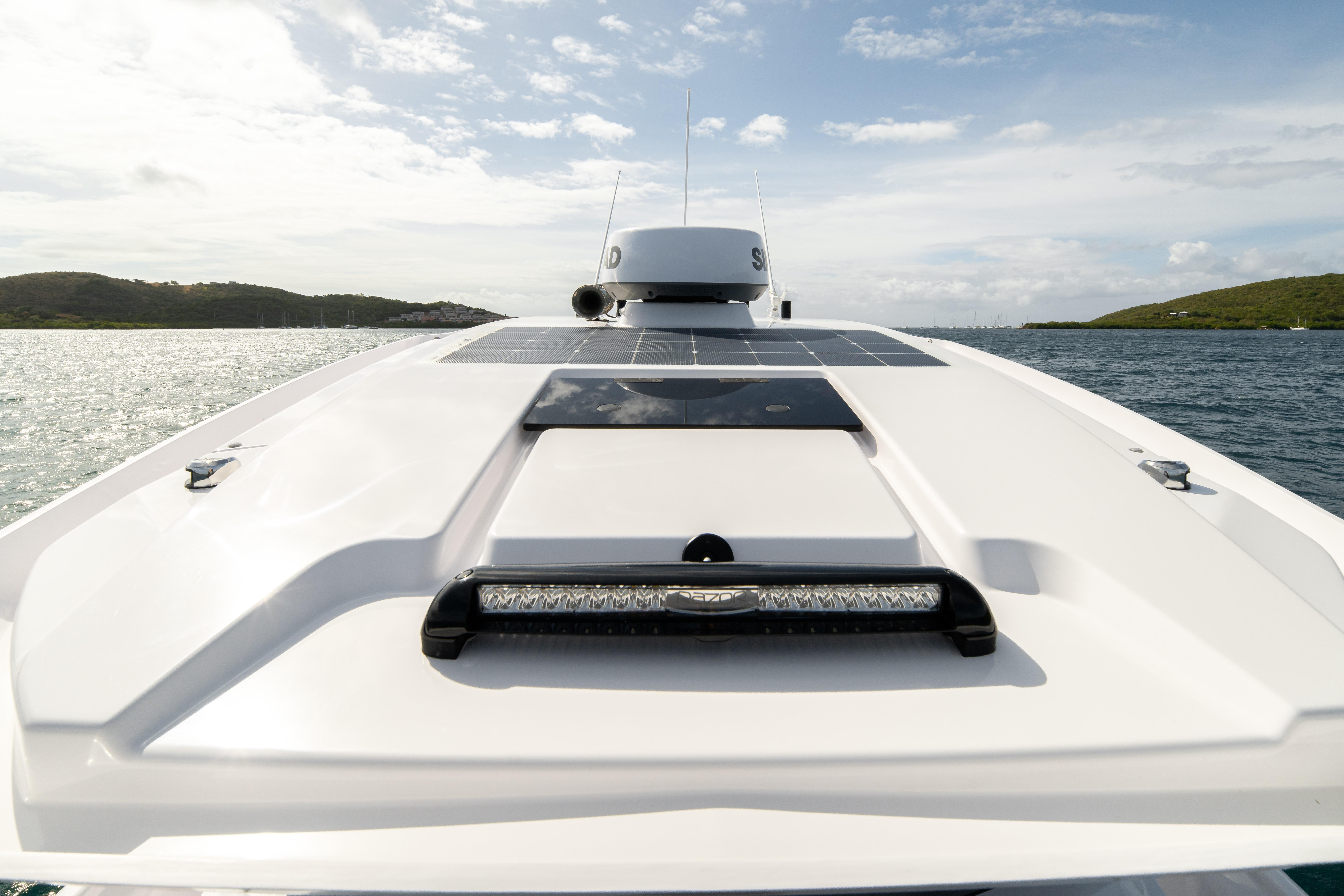2025 Axopar 29 CCX boat on water, showcasing sleek design and solar panels.