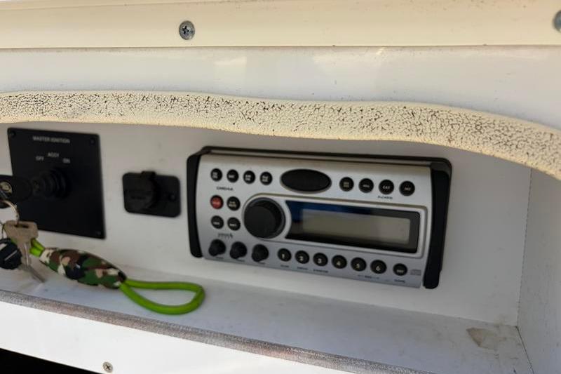 Control panel of a 2007 Sea Ray 240 Sundeck boat with radio and keys.