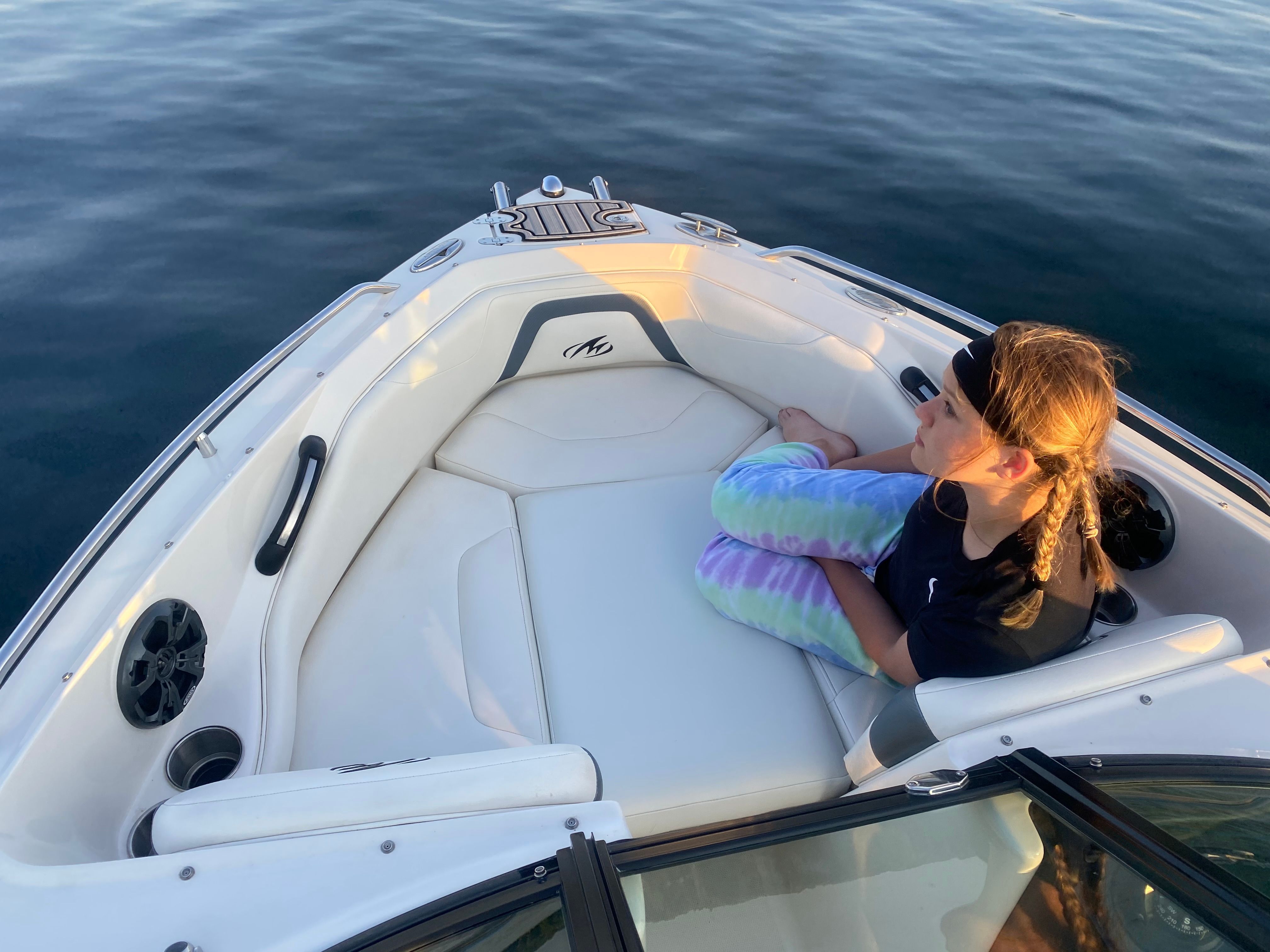 Girl sitting on a 2013 Monterey 204FSX boat.