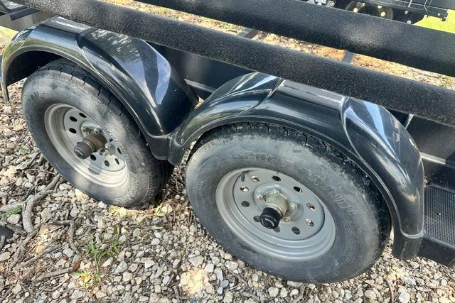 Trailer wheels for 2021 Bennington L Bowrider 25 Quad Bench on gravel.