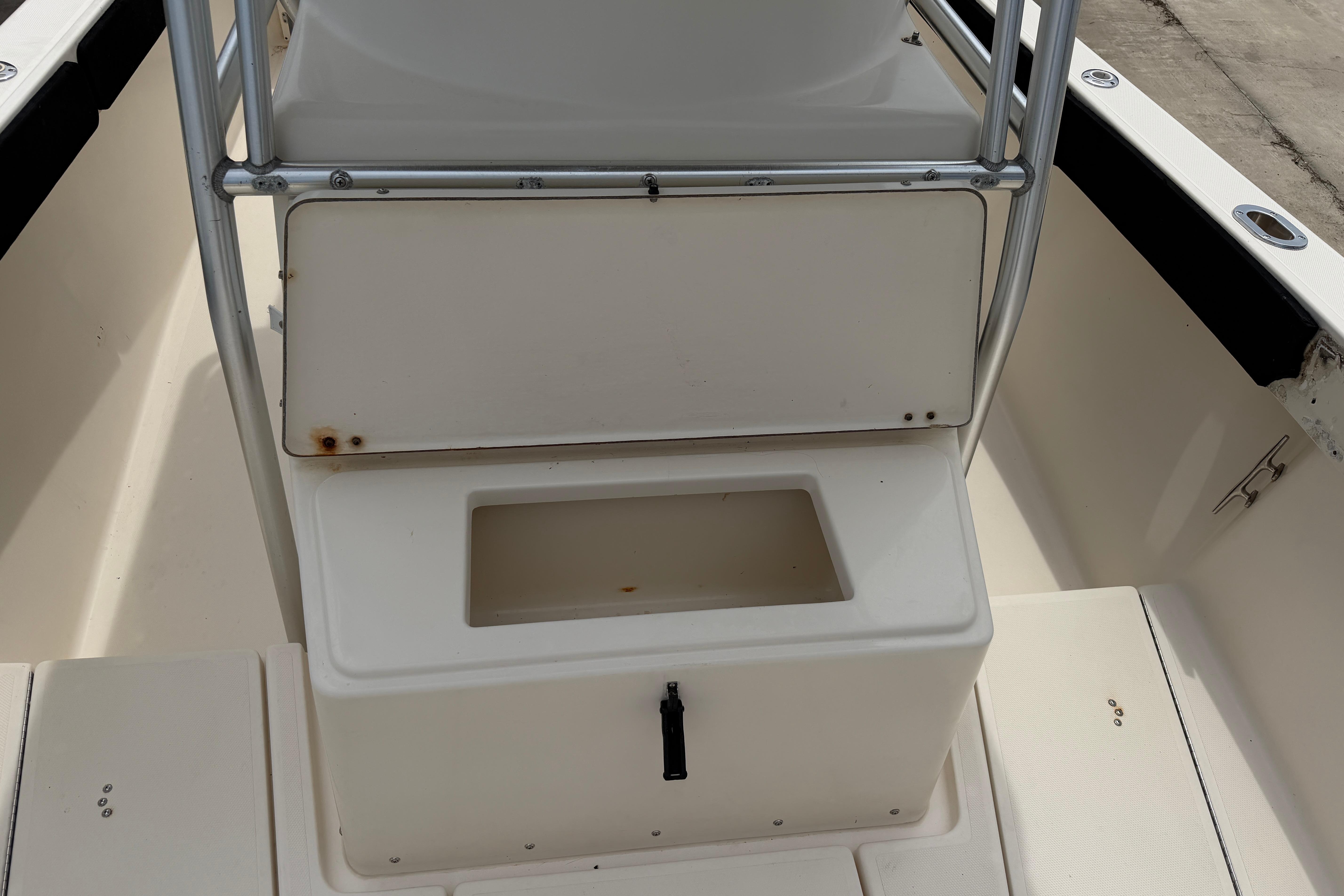 2003 KenCraft 235 Challenger boat interior with storage compartment and seating area.