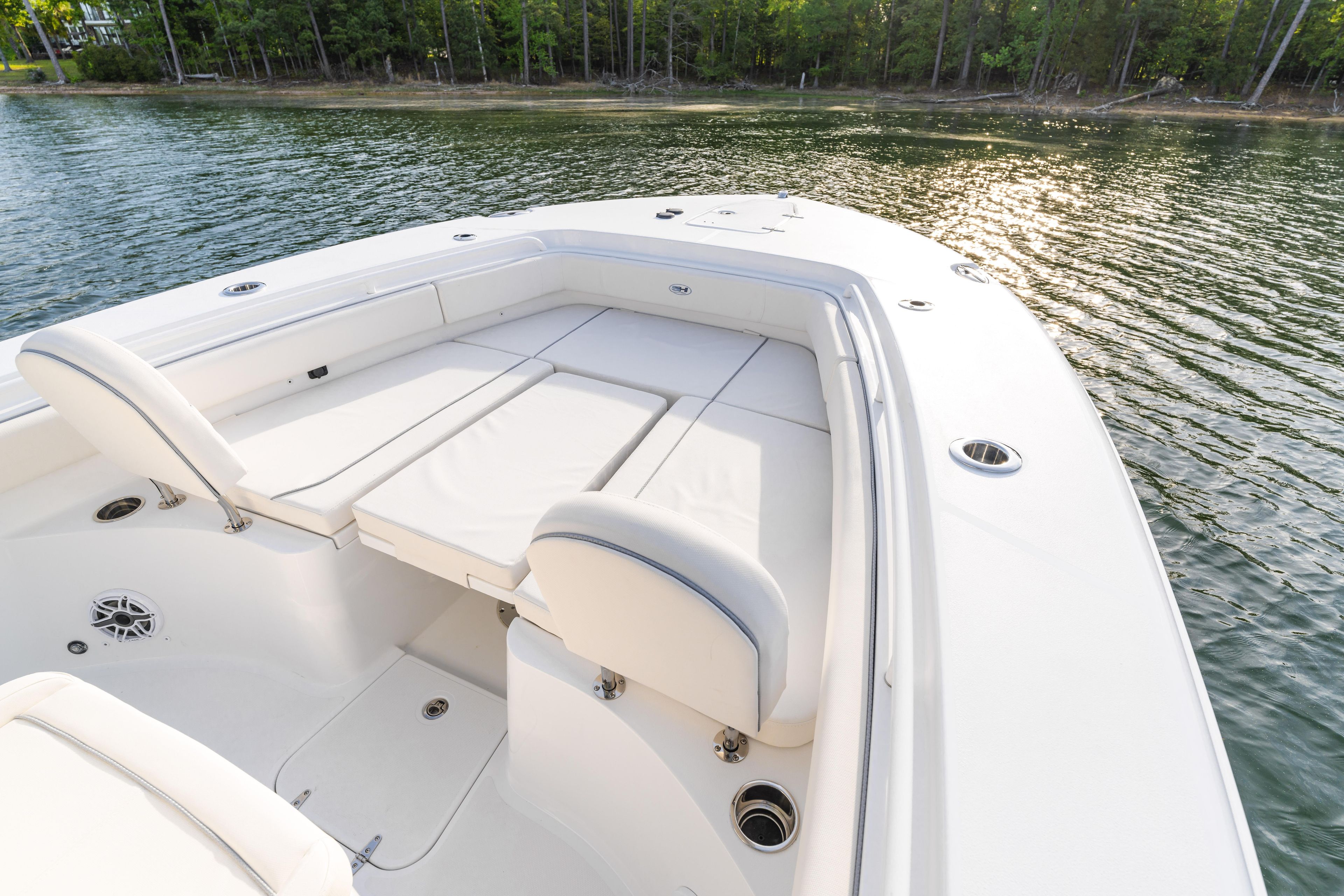 2027 Sea Hunt Ultra 275 SE boat interior with cushioned seating on calm water.