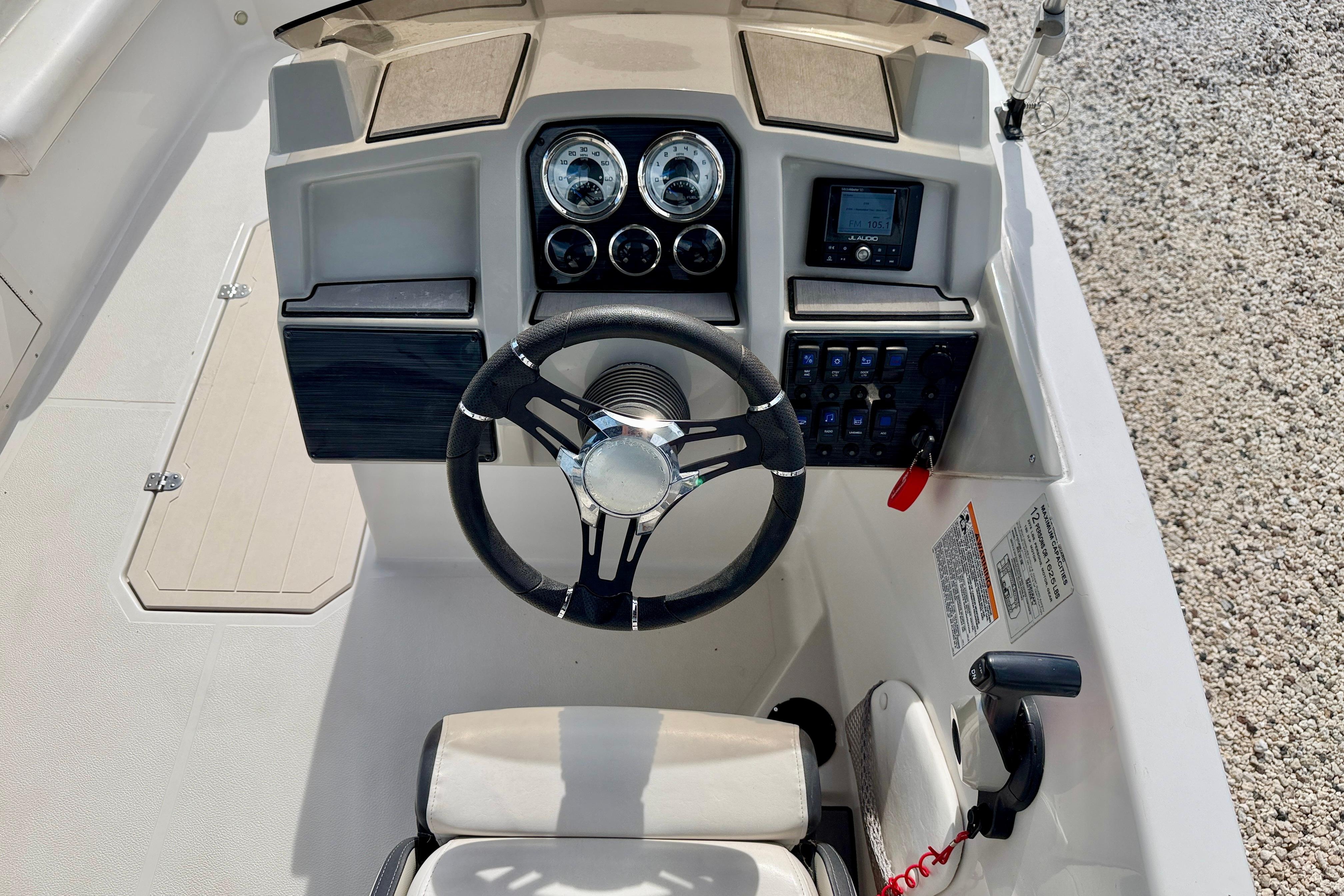 2021 Starcraft SVX 191 OB boat dashboard with steering wheel and control panel.