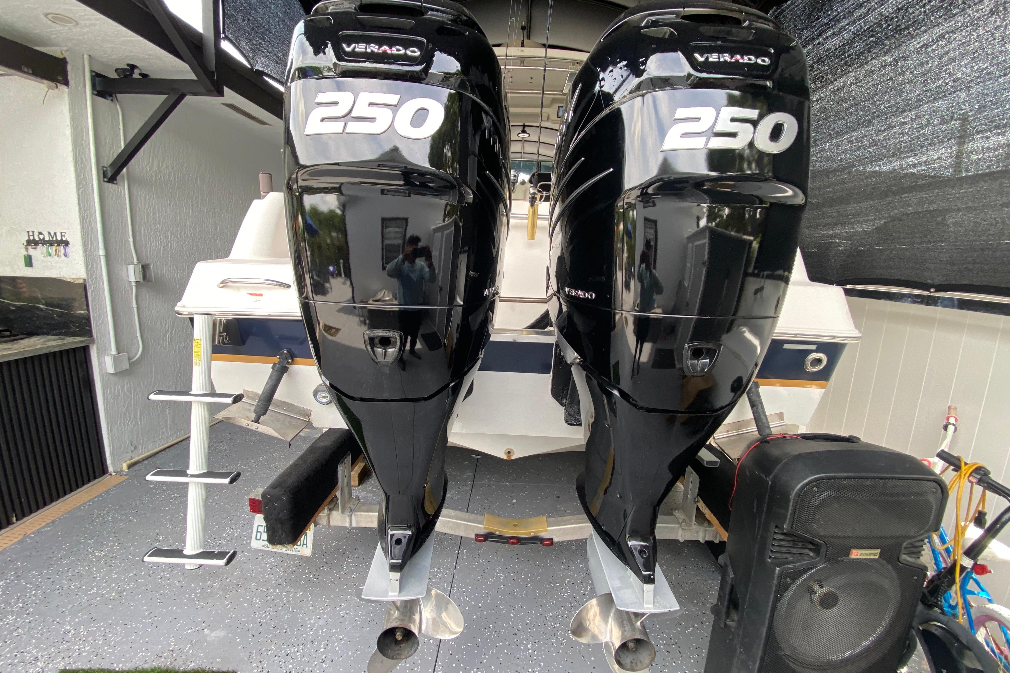 2005 Wellcraft 290 Coastal boat with twin 250 Verado engines in a garage.